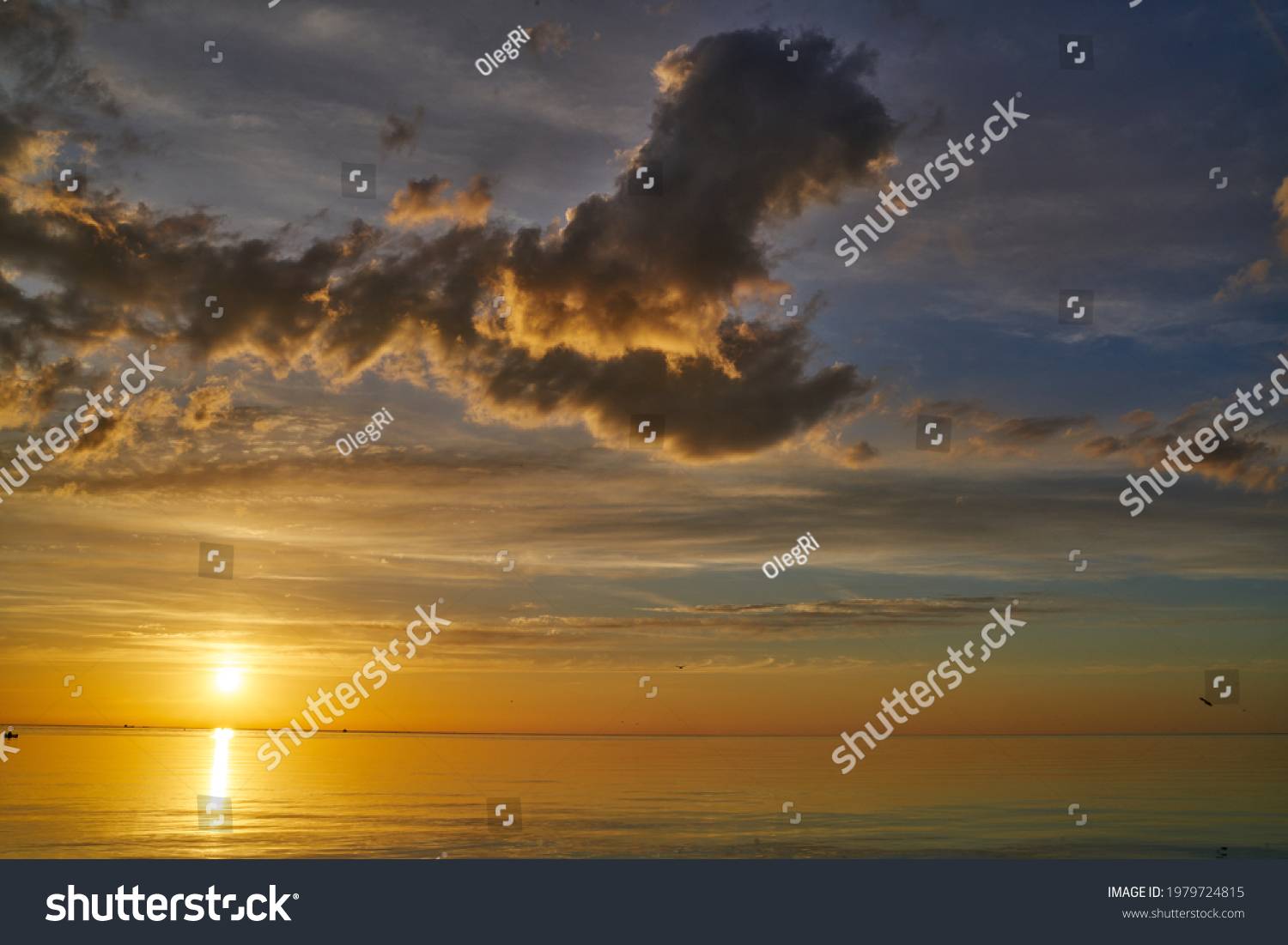Evening sky with dramatic clouds over the sea. Dramatic sunset over the sea. #1979724815