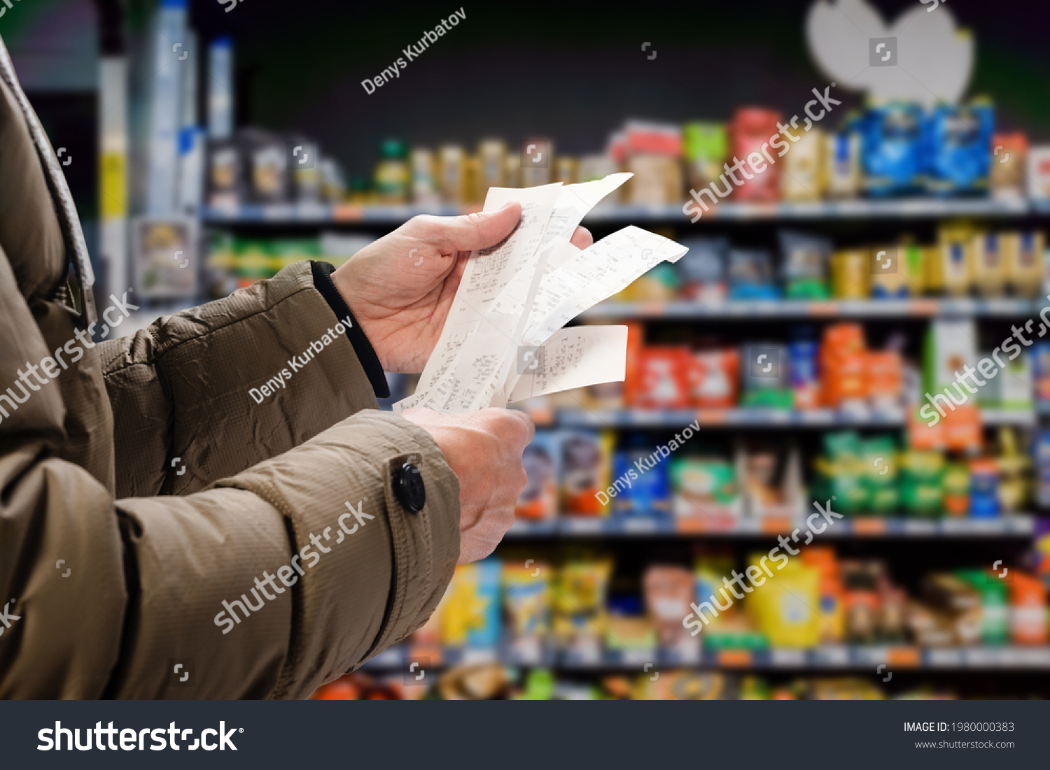 Minded man viewing receipts in supermarket and tracking prices #1980000383
