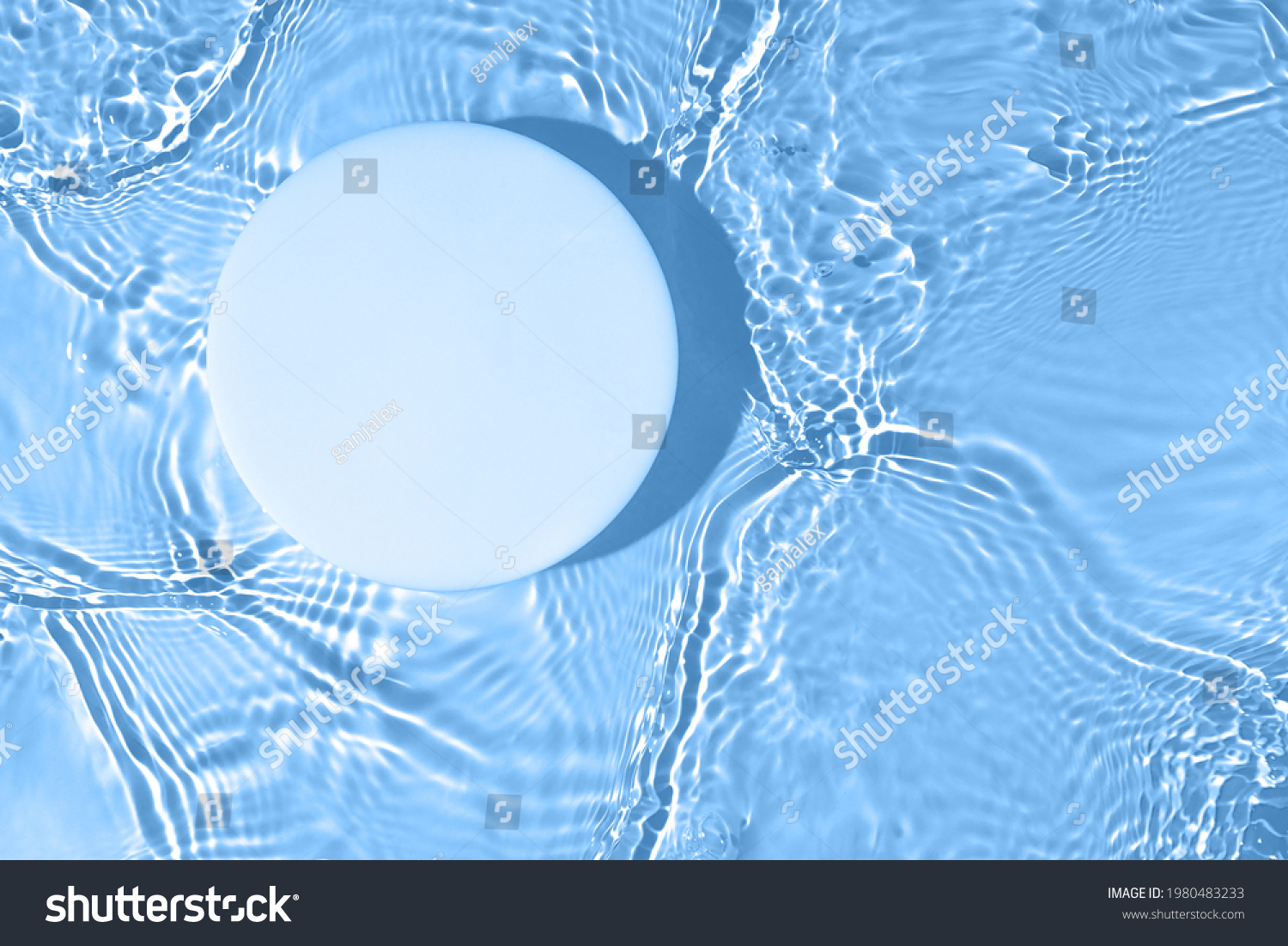 Empty white circle podium on transparent clear calm blue water texture with splashes and waves in sunlight. Abstract nature background for product presentation. Flat lay cosmetic mockup, copy space. #1980483233