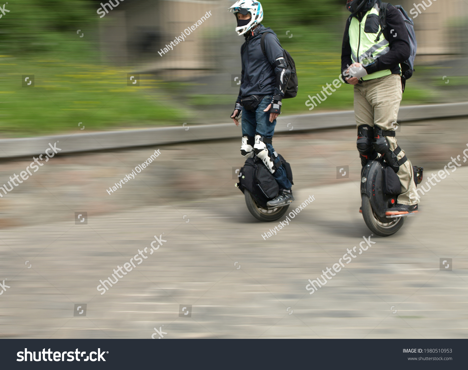 Two people ride electric unicycle along the street  #1980510953