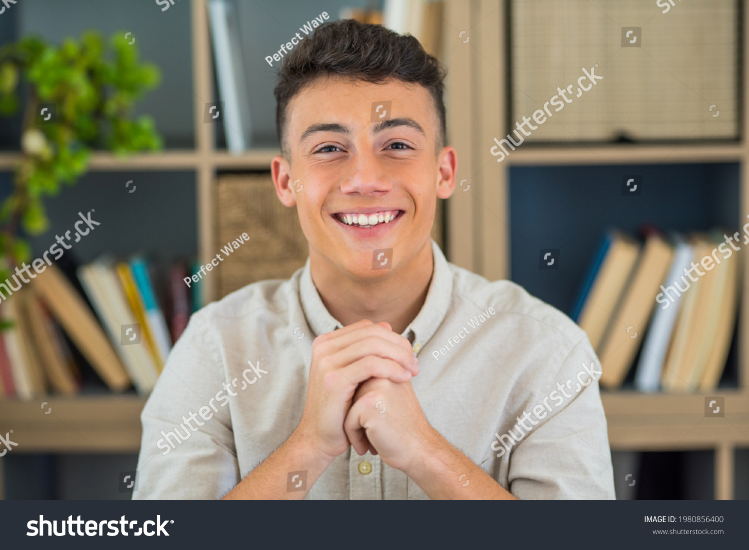 Portrait of one young and happy cheerful man smiling looking at the camera having fun. Headshot of male person working at home in the office. #1980856400