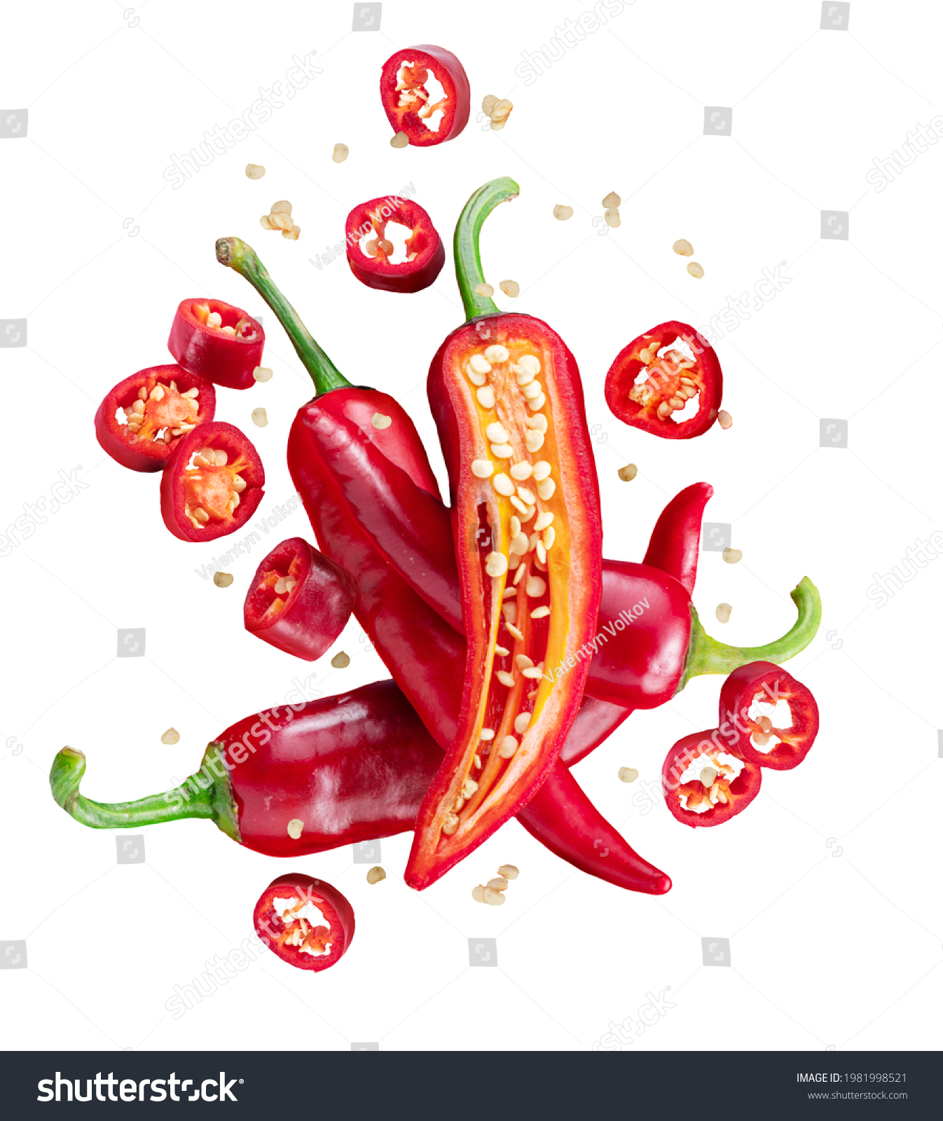 Fresh red chilli peppers and cross sections of chilli pepper with seeds floating in the air. File contains clipping paths. #1981998521
