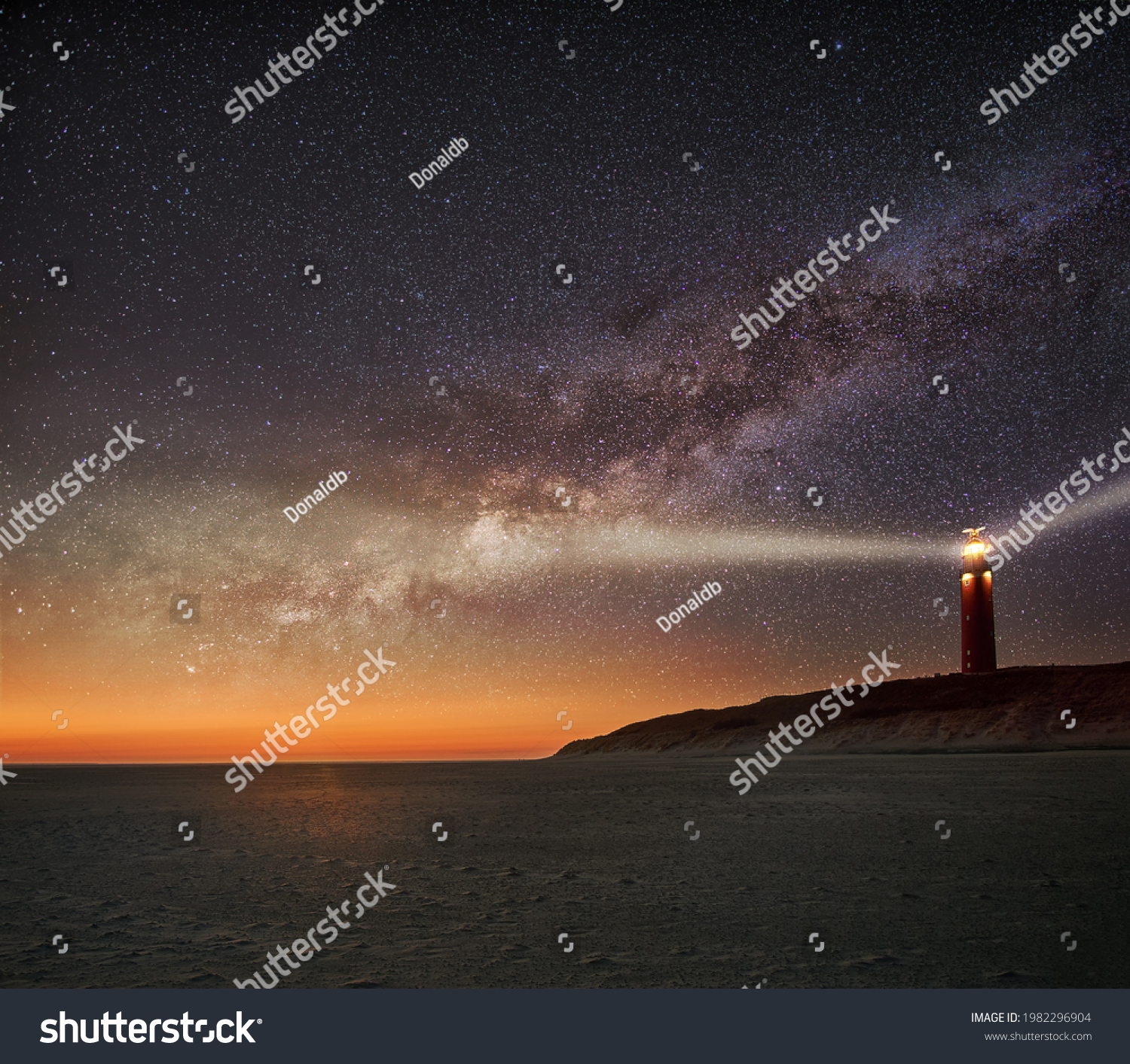 Night image of the Texel lighthouse serving as a navigation beacon for ships with starry nightsky with Milky way galactic core #1982296904