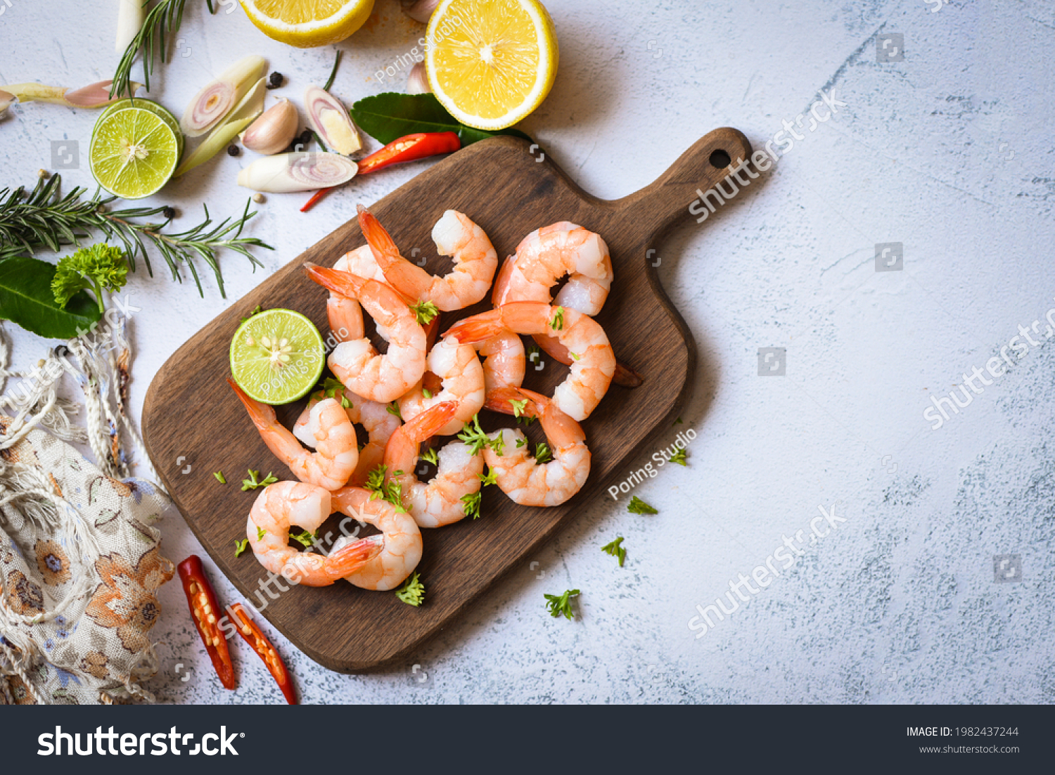 Shrimp peeled on wooden cutting board background on the table food kitchen, Fresh shrimps prawns seafood lemon lime with herbs and spice #1982437244