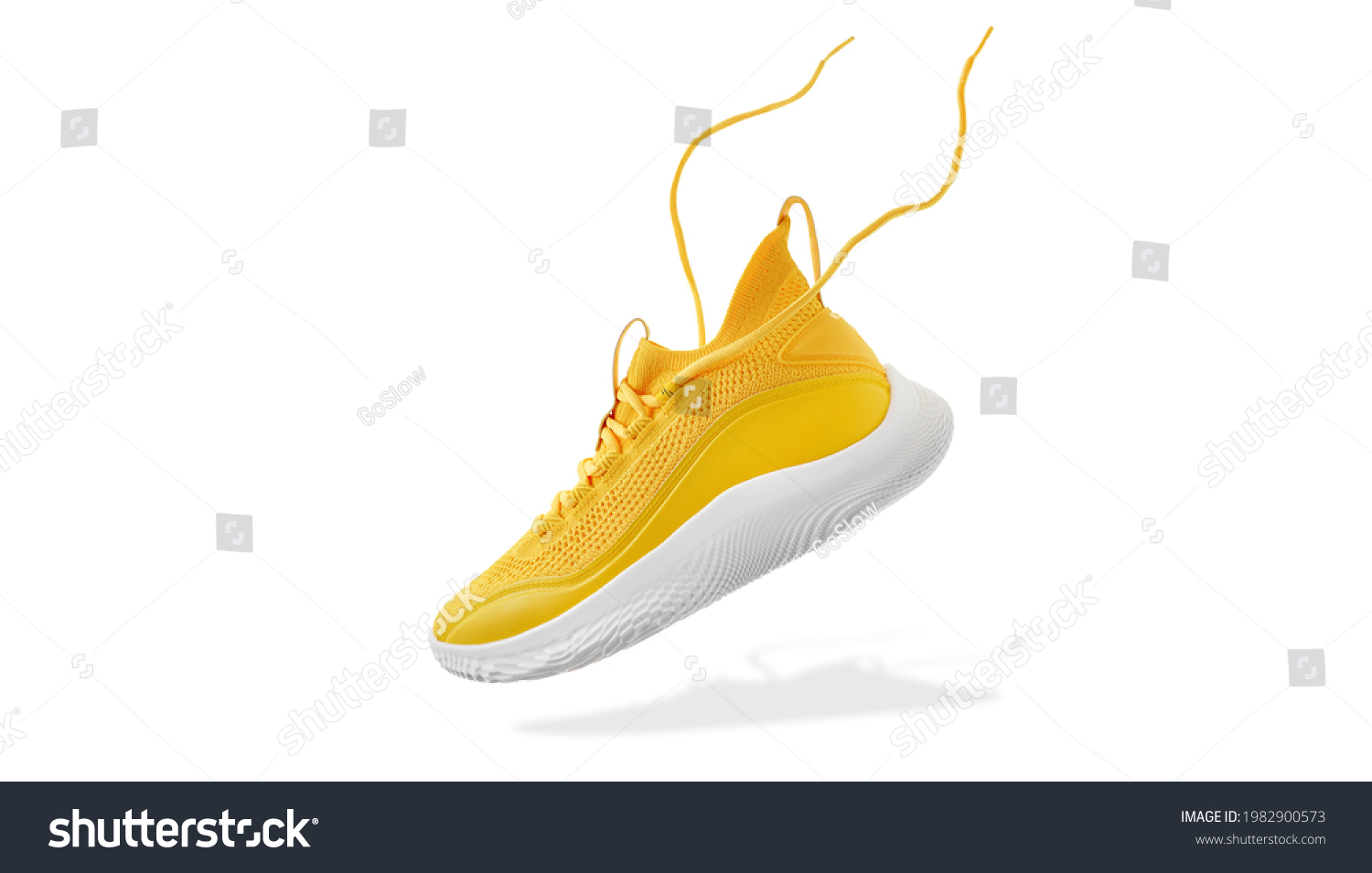 Flying yellow leather womens sneaker isolated on white background. Fashionable stylish sports casual shoes. Creative minimalistic layout with footwear. Mock up for design advertising for shoe store #1982900573