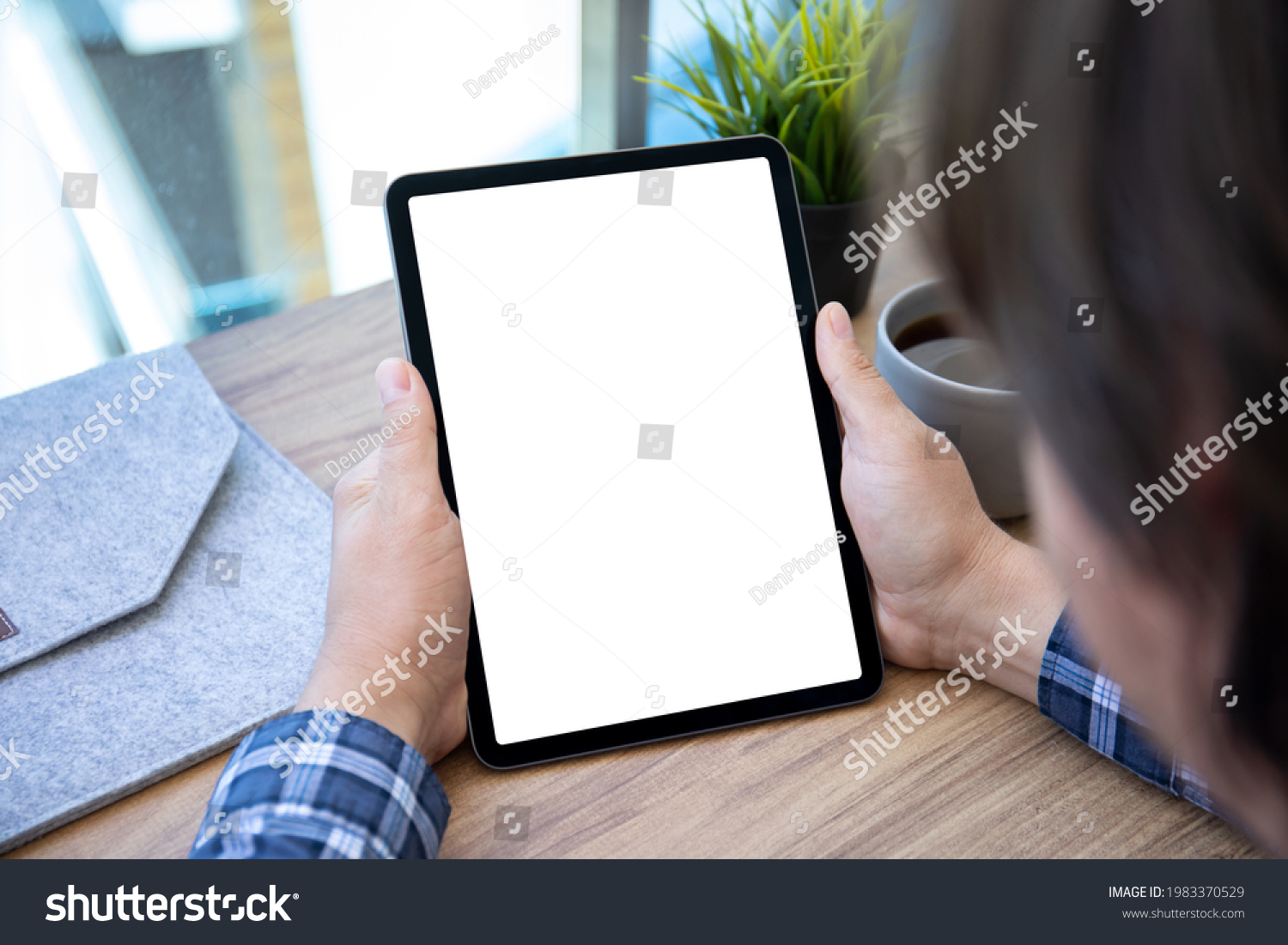 male hands hold computer tablet upright with isolated screen over table in office  #1983370529