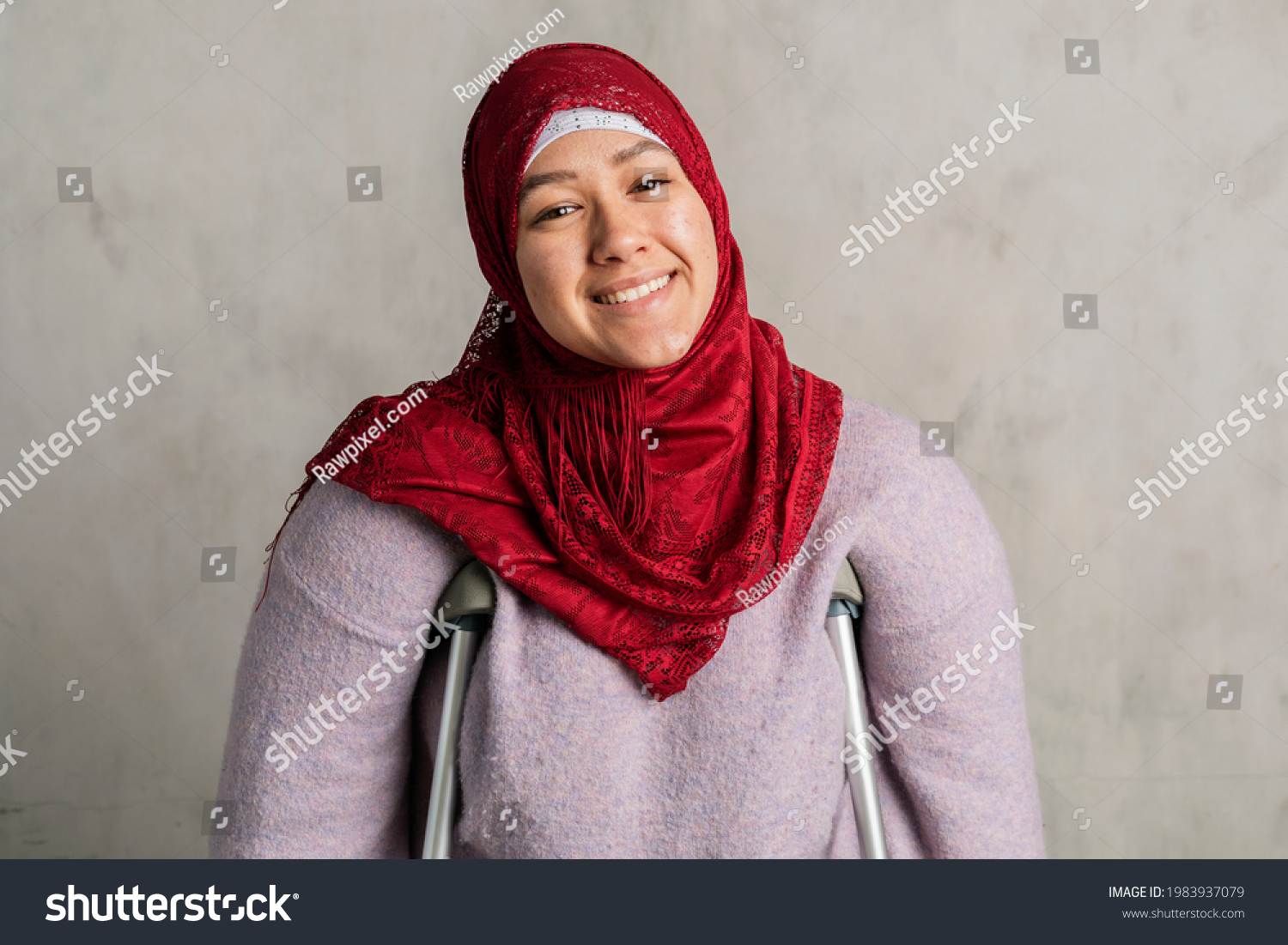 Happy Muslim woman with crutches #1983937079