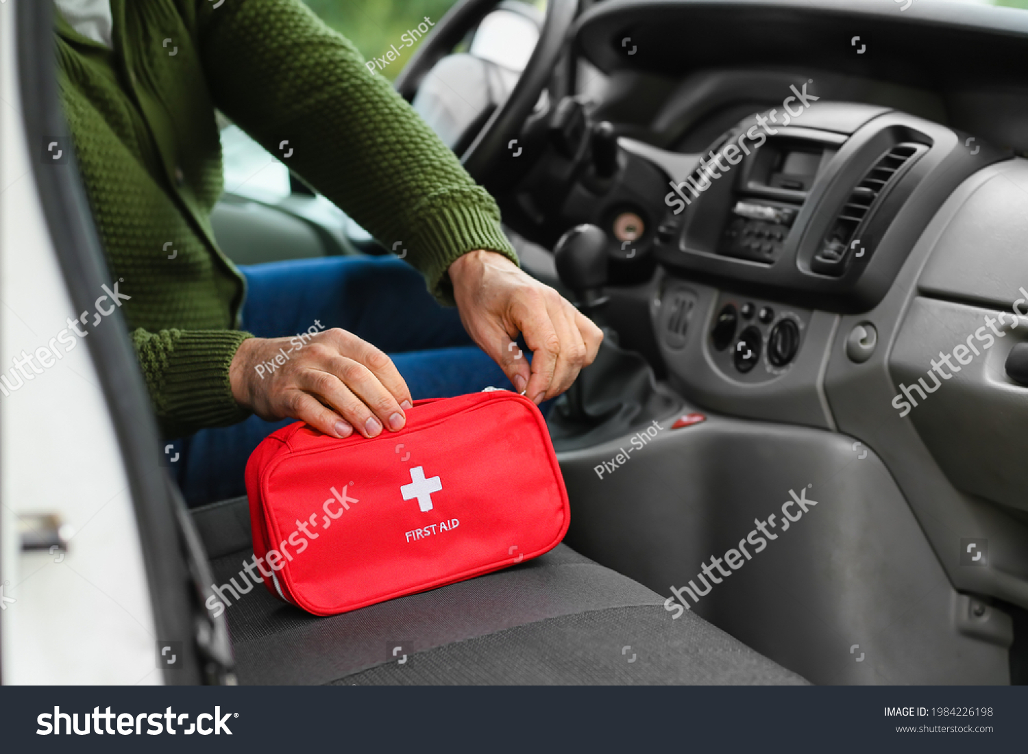 Man with first aid kit in car #1984226198