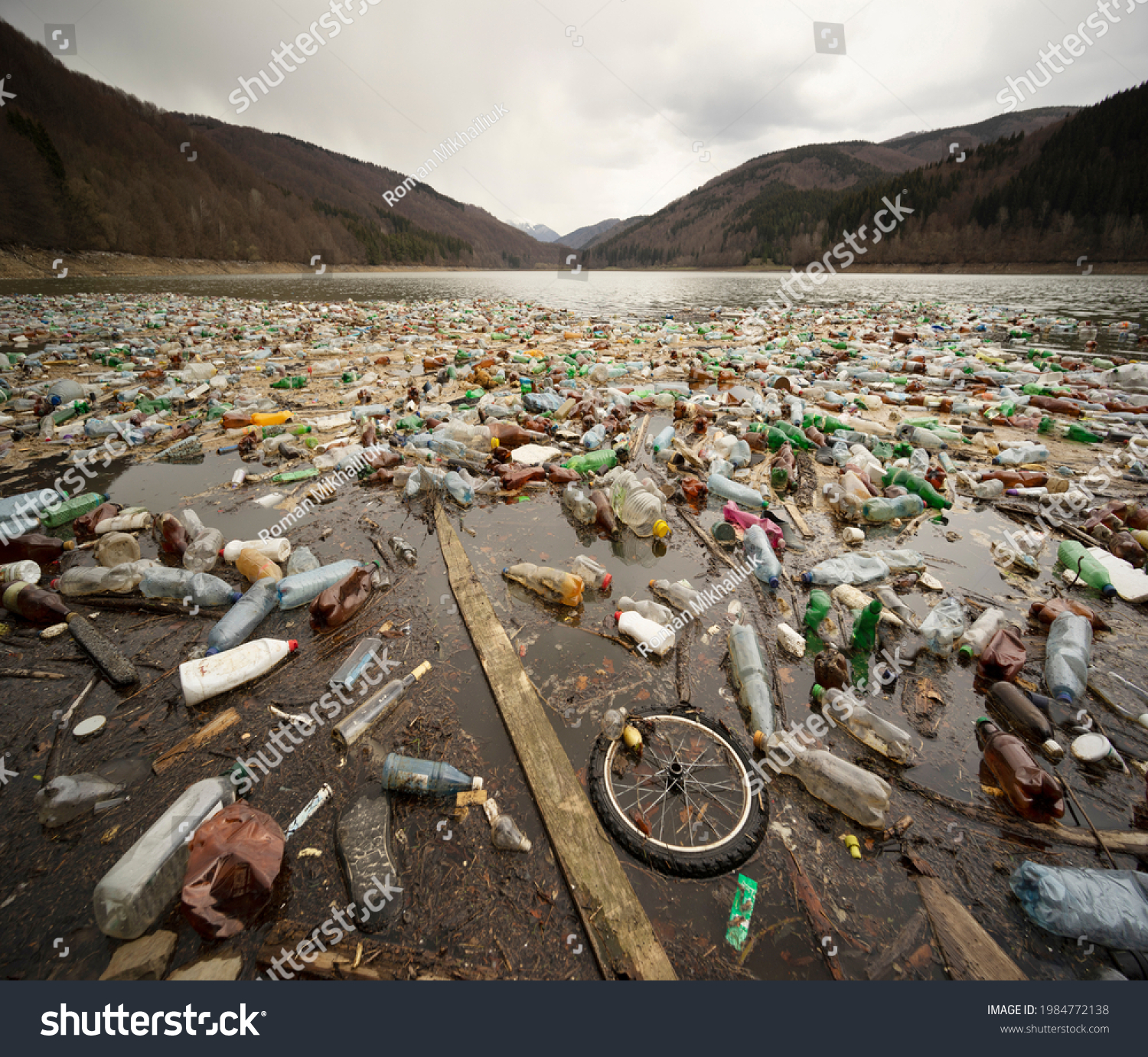 Environmental disaster in Transcarpathia, Ukraine. Residents of mountain villages throw plastic waste directly into the rivers, which bring it to the reservoir and dump it on its banks. Low ecology. #1984772138