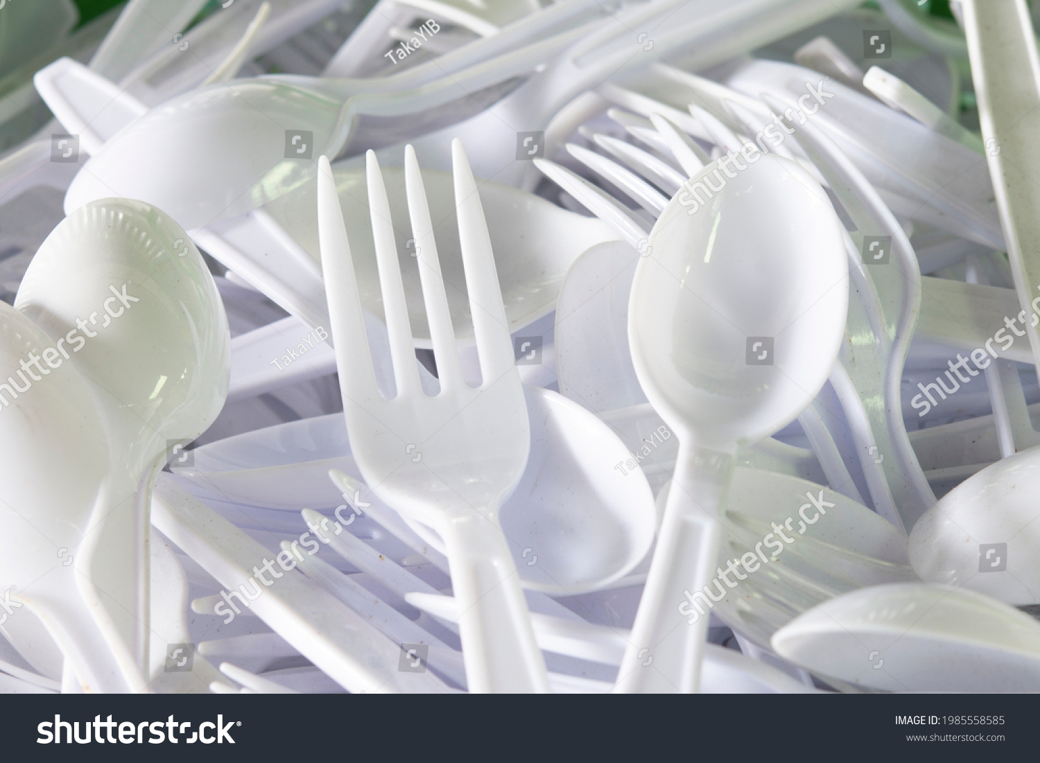 Lots of white plastic forks and spoons. #1985558585