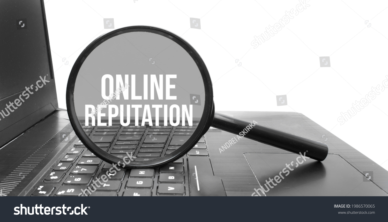 A concept image of a magnifying glass isolated white background with a word ONLINE REPUTATION zoom inside the glass on laptop keyboard #1986570065