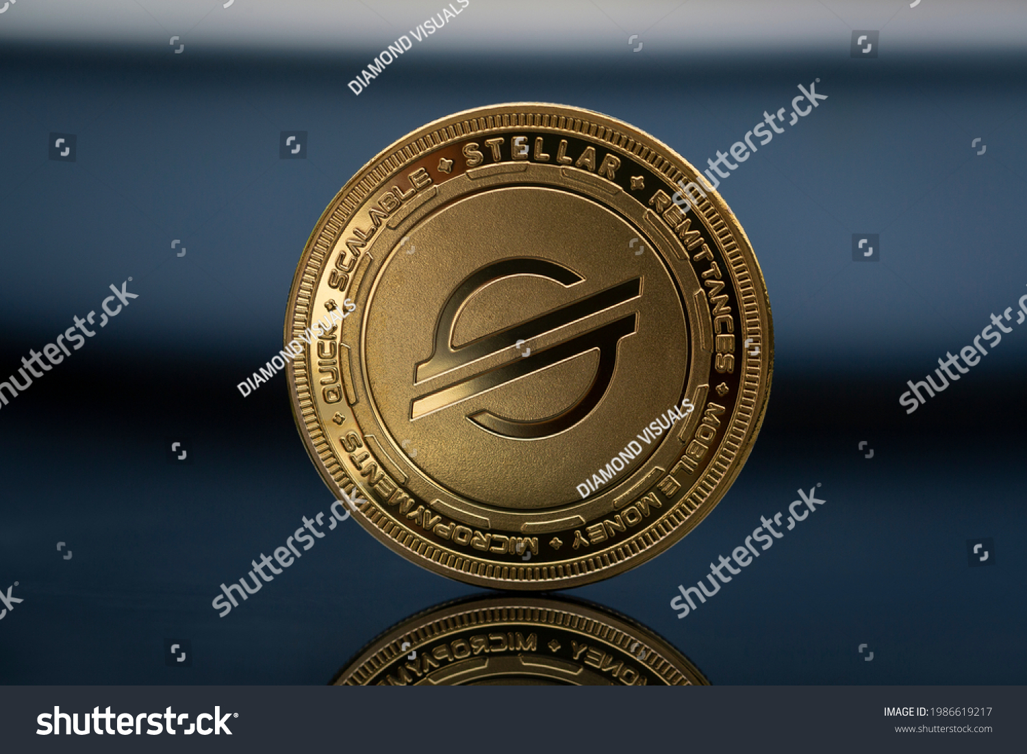 Stellar XLM Lumens Cryptocurrency physical coin placed on the  reflective blue surface #1986619217