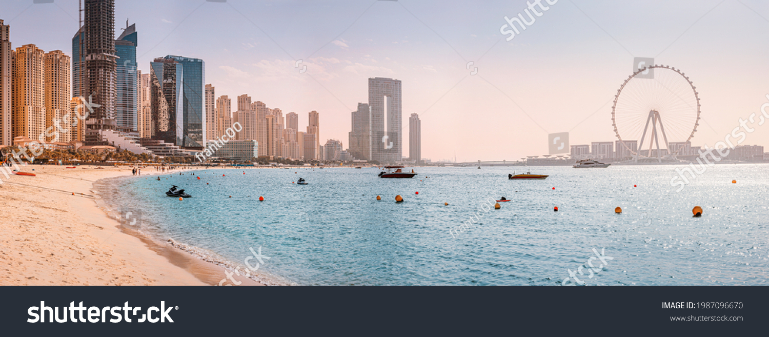 Panoramic views of the Persian Gulf beach and Bluewaters Island with the worlds famous largest Ferris wheel Dubai Eye and numerous skyscrapers with hotels and residences #1987096670