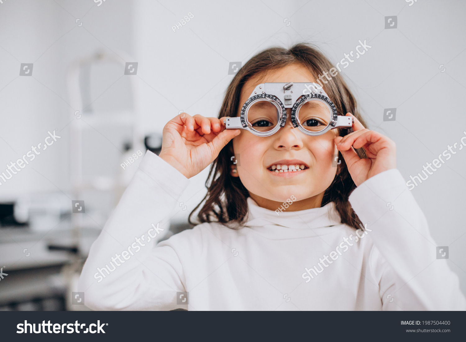 Little girl checking up her sight at ophthalmology center #1987504400