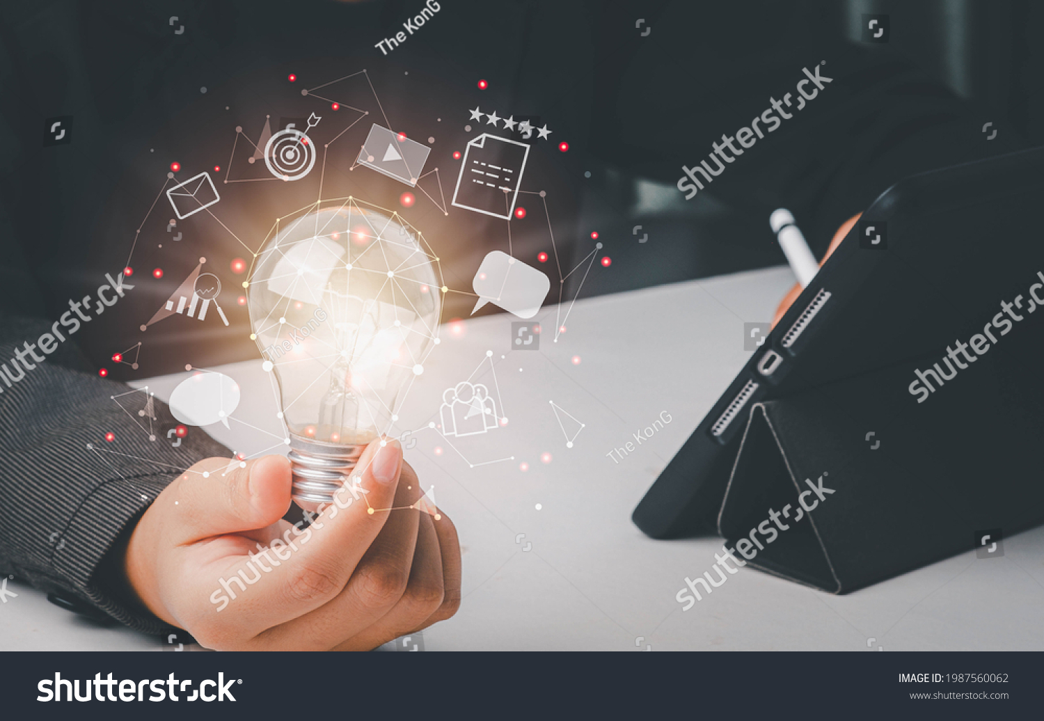 Content marketing concept. Businessman holding light bulb of creative idea and usering tablet research best content for marketing plan. Conneting line of communication icon.  #1987560062