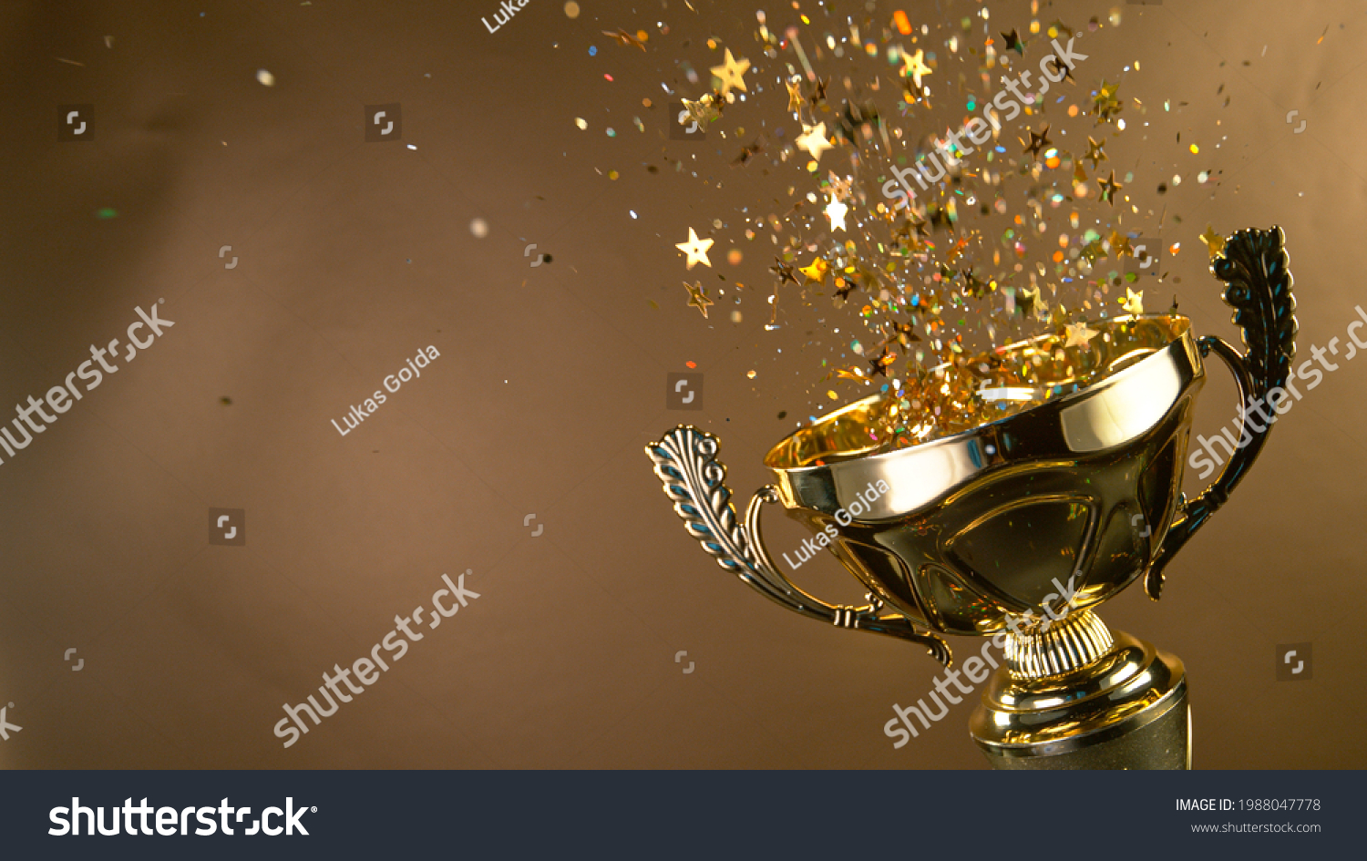 Champion golden trophy isolated on black background. Concept of success and achievement. #1988047778