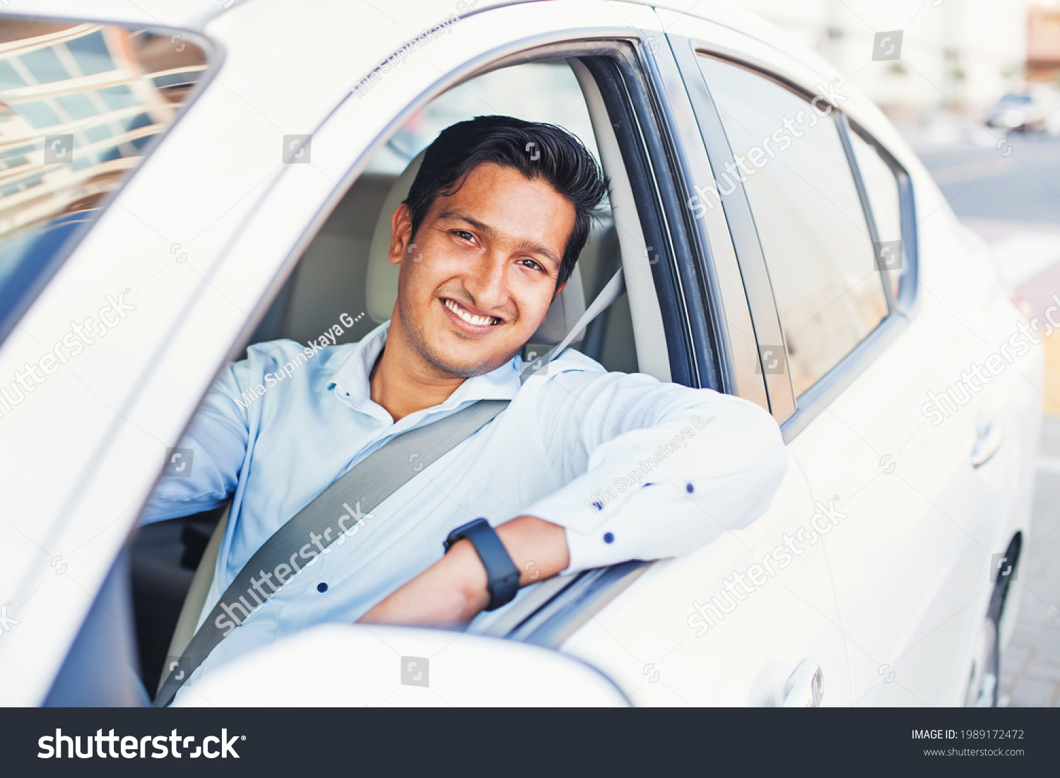 Young handsome Indian man proudly driving his own car #1989172472