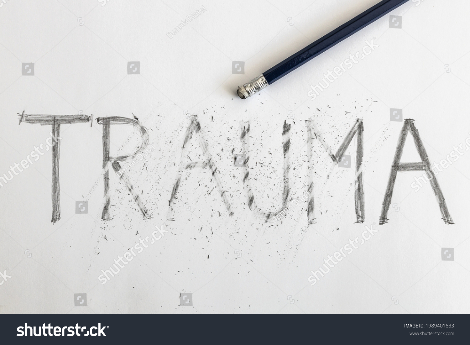 Erasing trauma. Trauma written on white paper with a pencil, partially erased with an eraser. Symbolic for overcoming trauma or treating trauma.   #1989401633