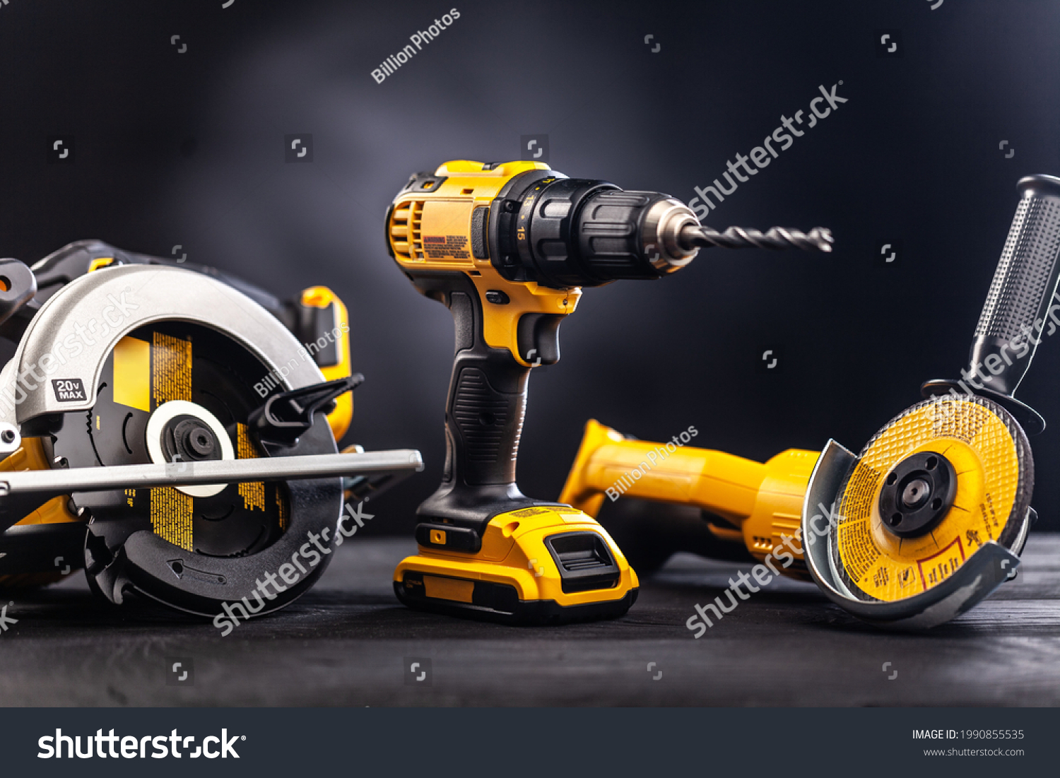 Construction carpentry tools electric corded circular saw cordless drill on background #1990855535