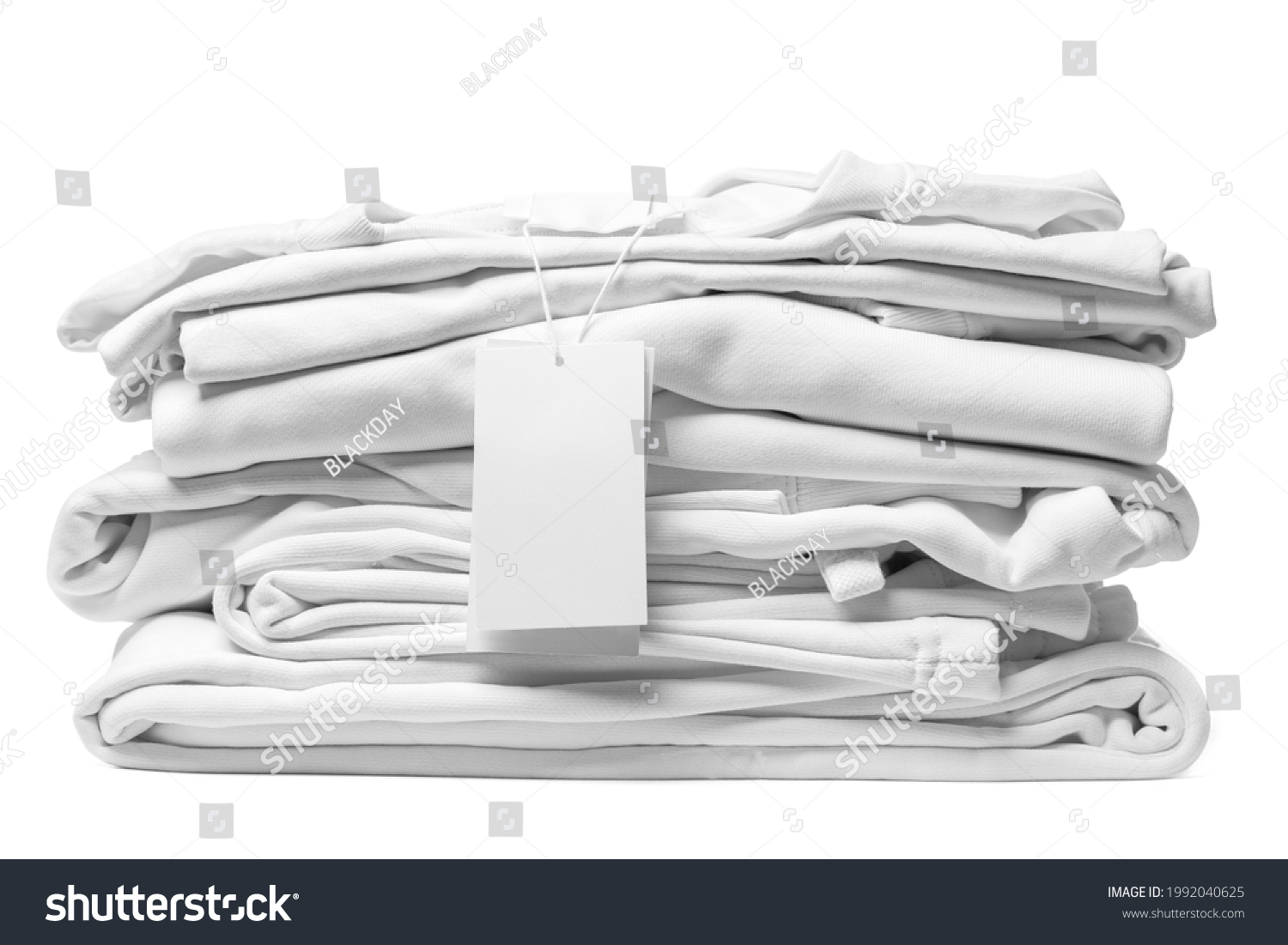 Stack of new white clothes with a blank garment tag isolated on white background #1992040625