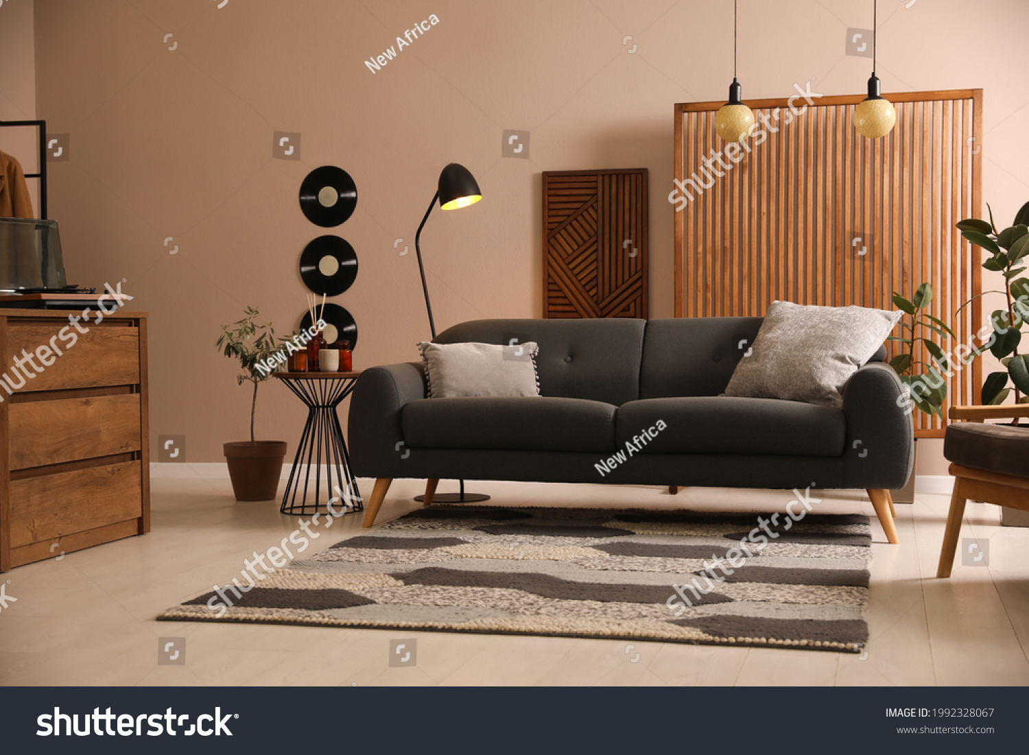 Stylish living room interior with comfortable dark sofa #1992328067