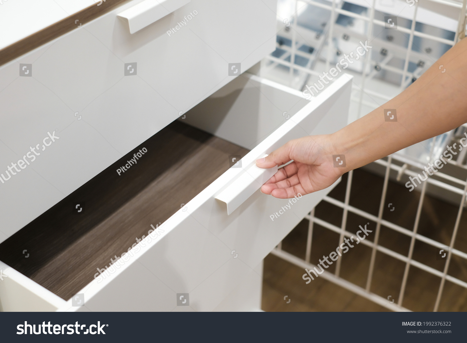 man open shelf, pull open drawer wooden in cabinet.	 #1992376322