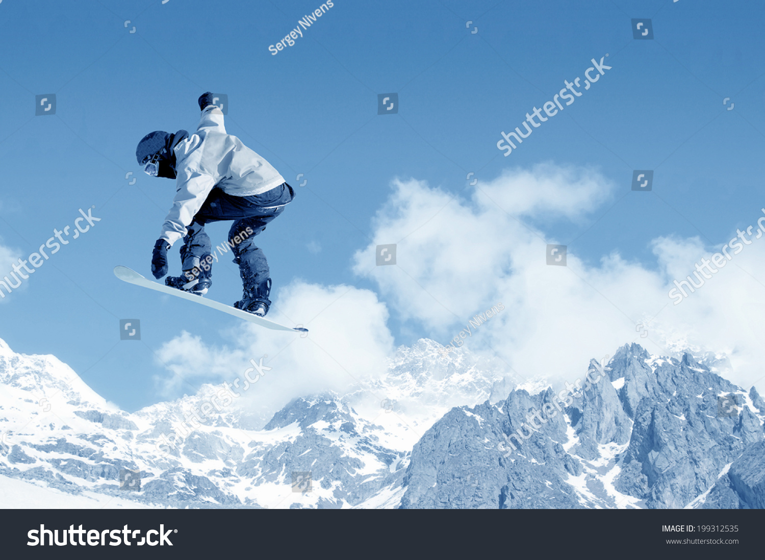 Snowboarder making jump high in clear sky #199312535