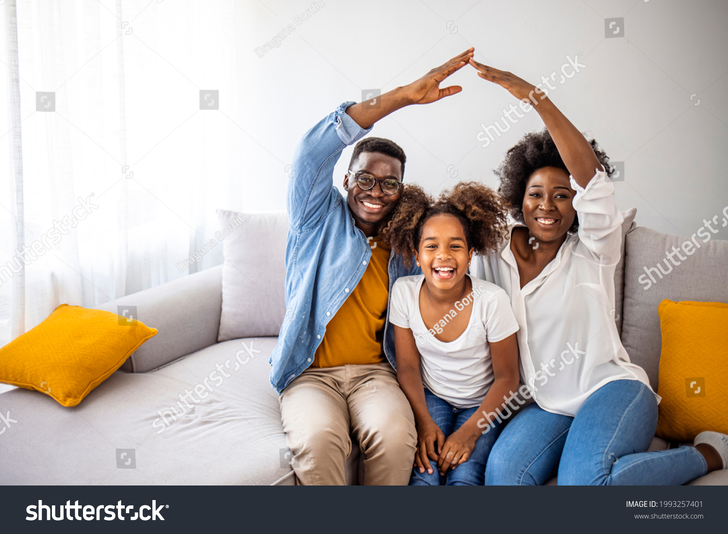 Happy family forming house roof with their hands at home. Insurance concept. Concept of housing and relocation. happy family mother father and kids with roof at home #1993257401