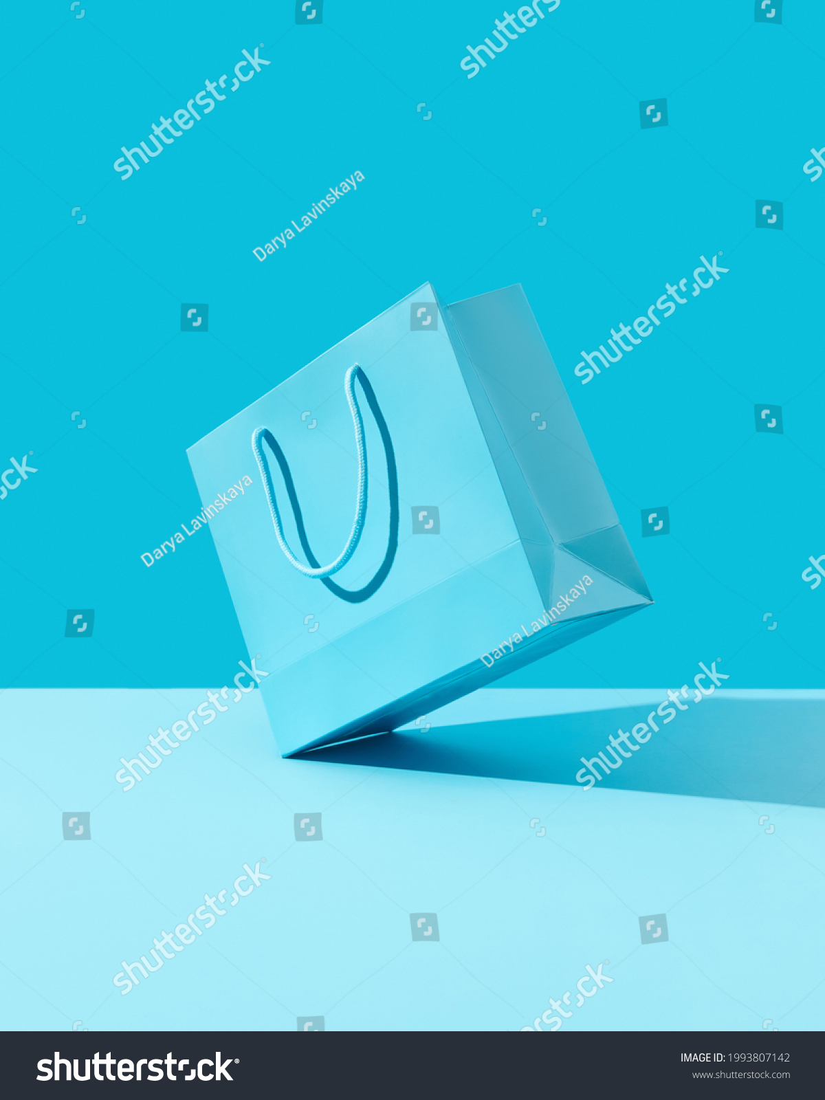 Paper shopping bag on blue background. Shopping sale delivery concept #1993807142