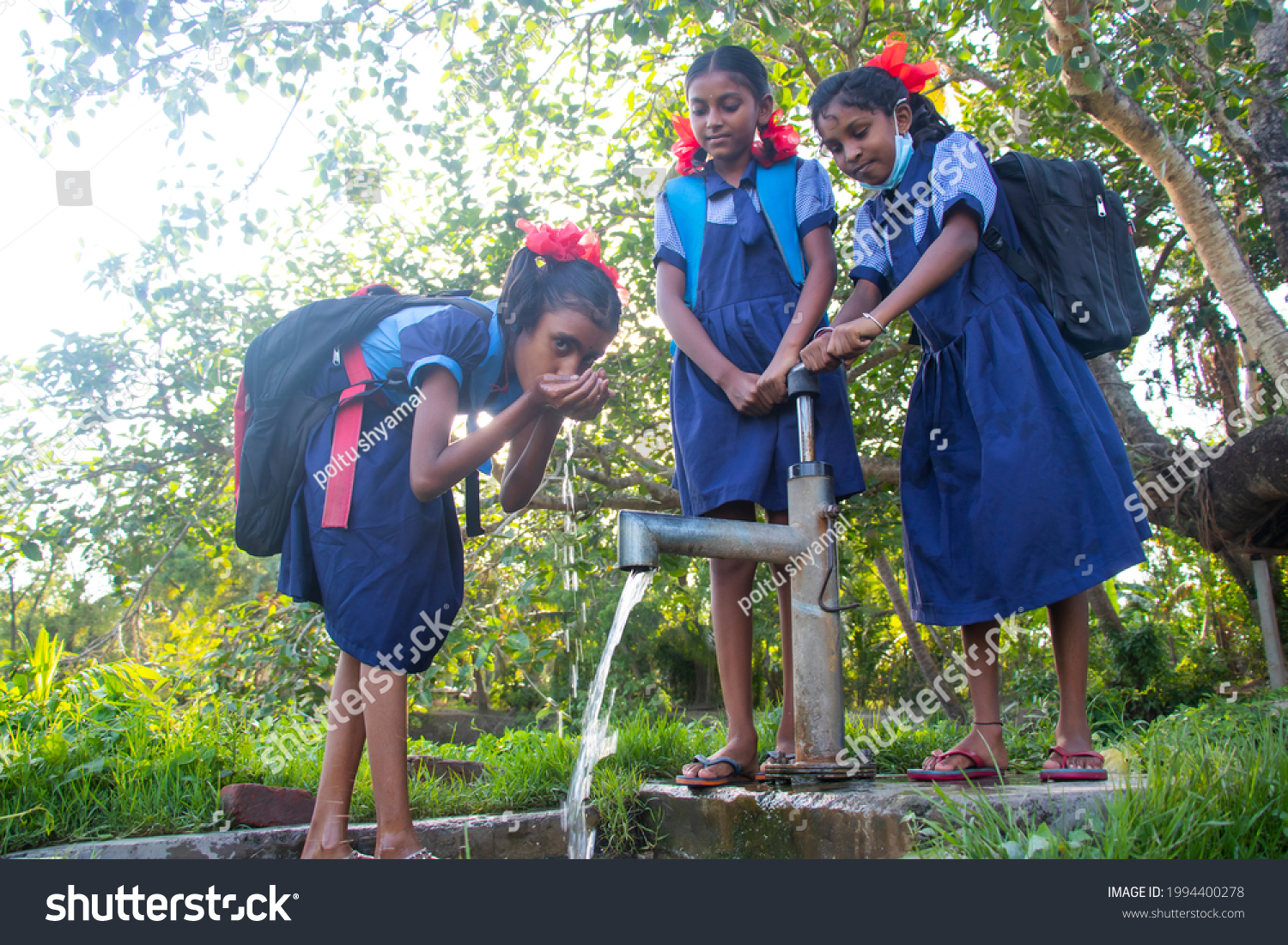 Indian Rural School Girls drinking water from Tubewell at village #1994400278