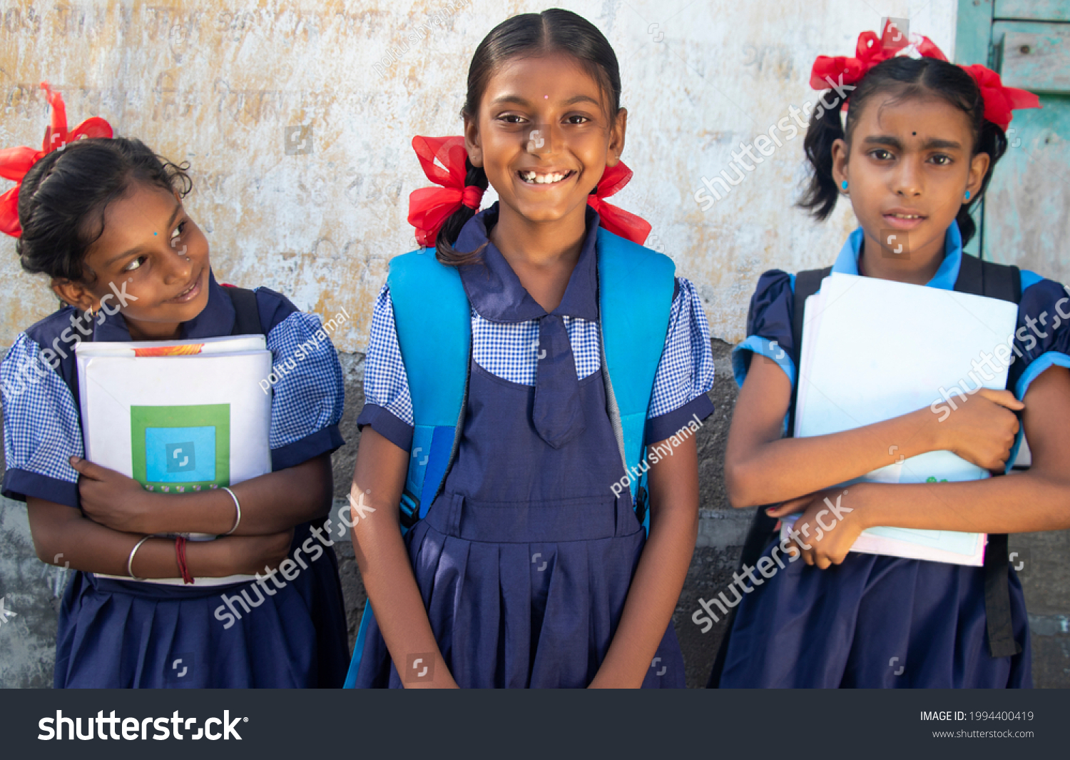Indian Rural School Girls Holding Books Standing in School #1994400419