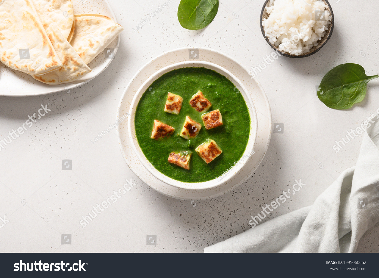 Indian vegetarian cuisine Palak Paneer of spinach and paneer cheese with chapati and basmati rice on white background. View from above. #1995060662