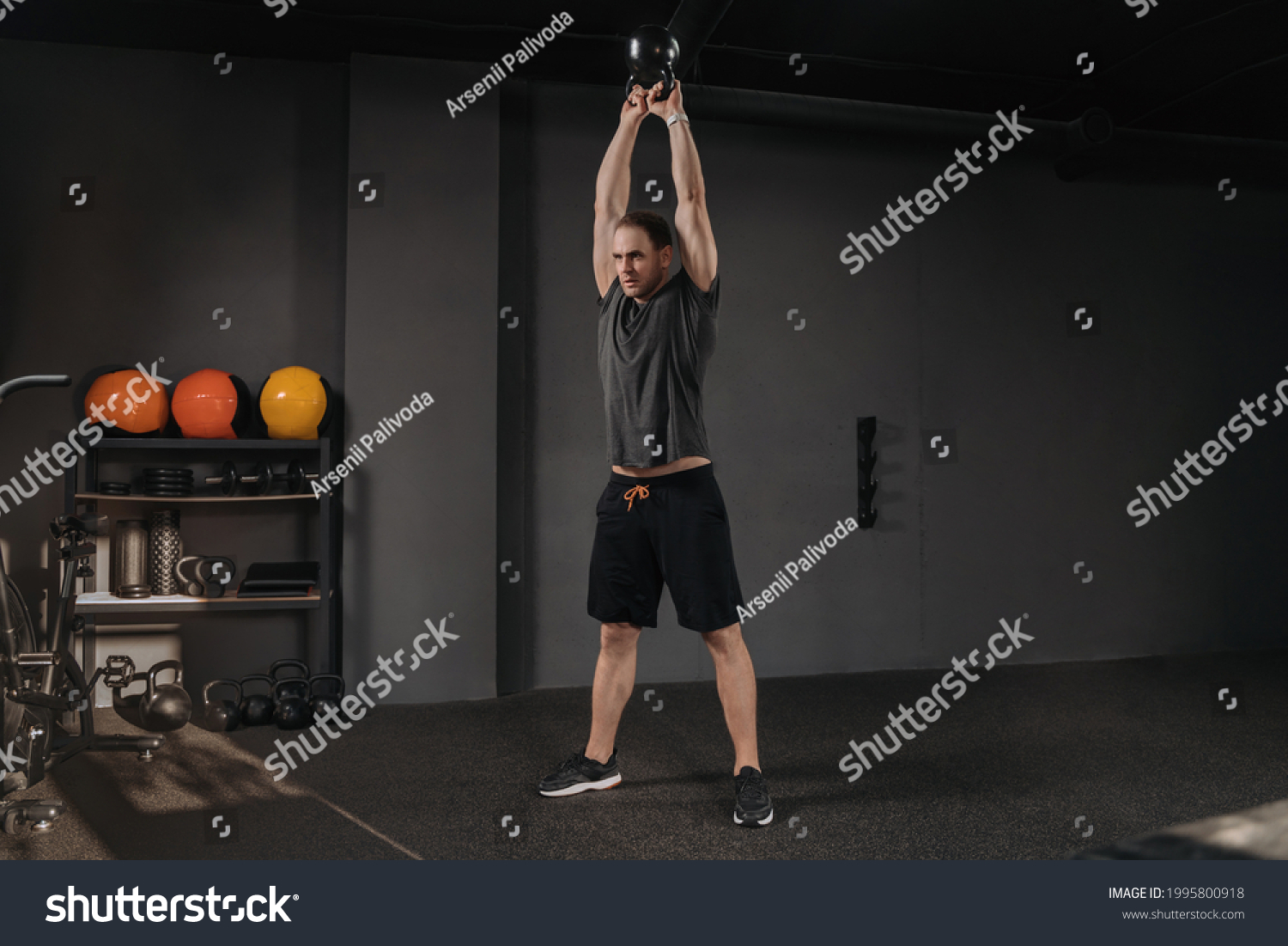 Young sportsman doing kettlebell swings at sport crossfit gym. Copyspace. Muscular strong crossfit man exercising with kettlebell, have weightlift functional training, working out #1995800918