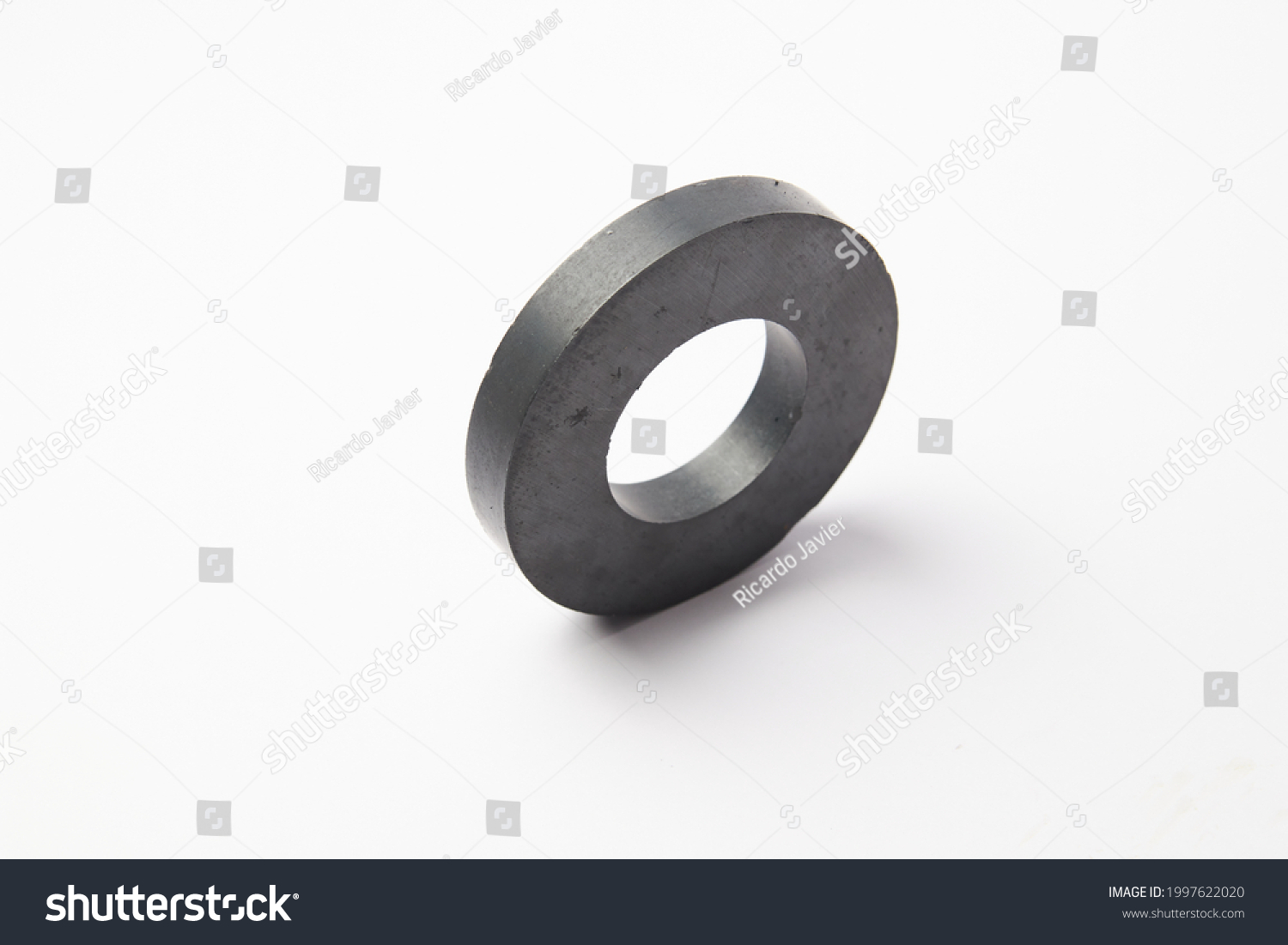 Circular black ferrite ring magnet isolated on a white background #1997622020