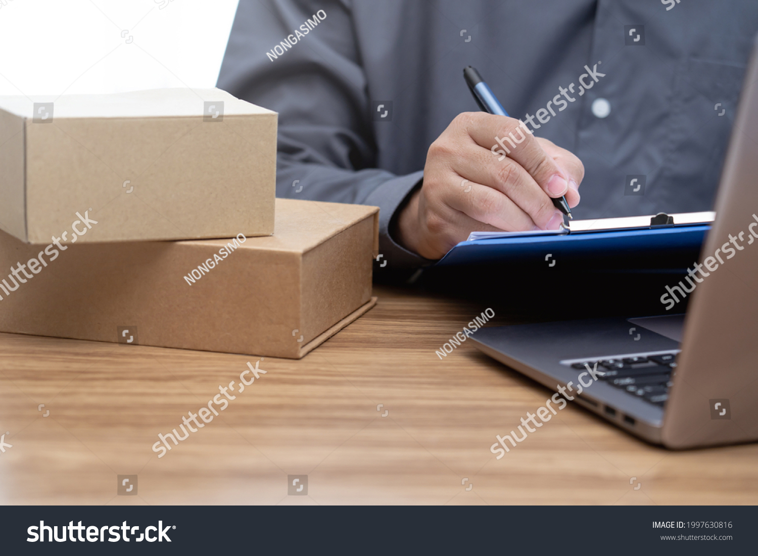 A man check order list inventory in stock from document and input data to computer : Online order concept #1997630816
