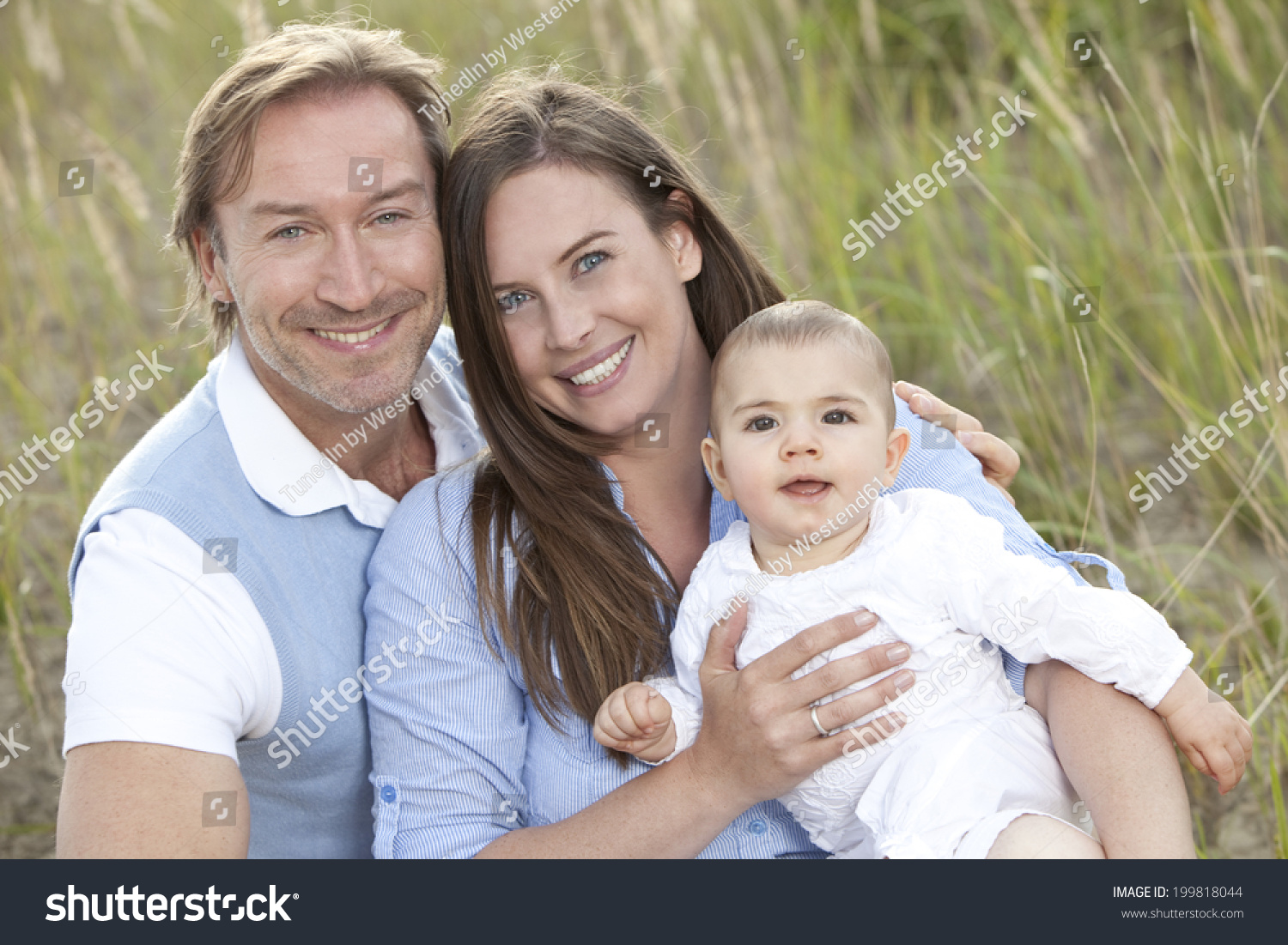 Germany, Bavaria, Mother and father with baby girl, smiling #199818044