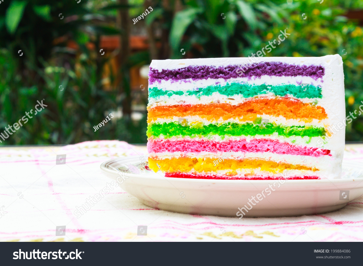 Close up piece of rainbow layer cake #199884086