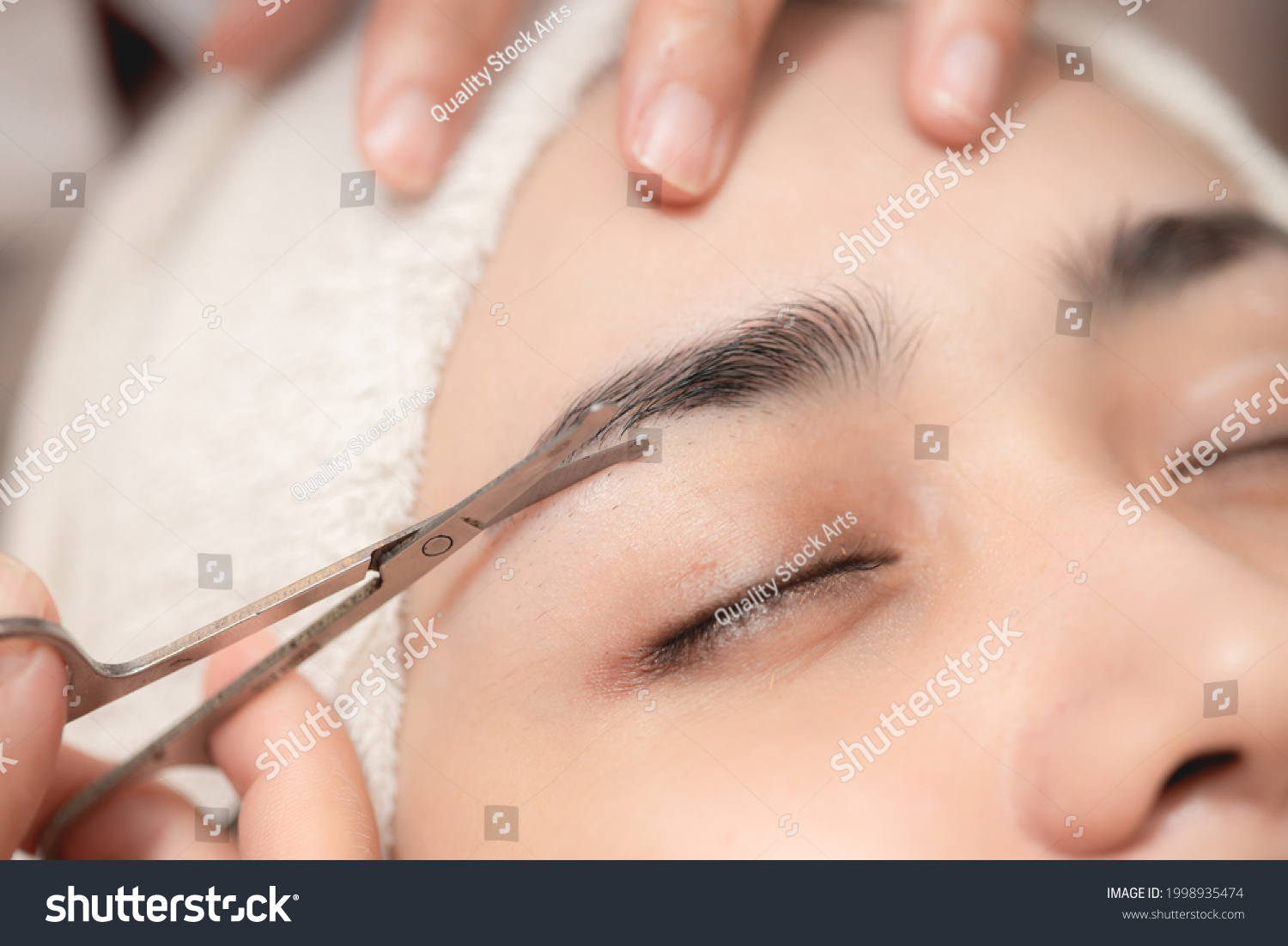 Eyebrows trimming service in spa salon, Face hair cutting and trim with small scissor tool for facial beauty women closeup. #1998935474