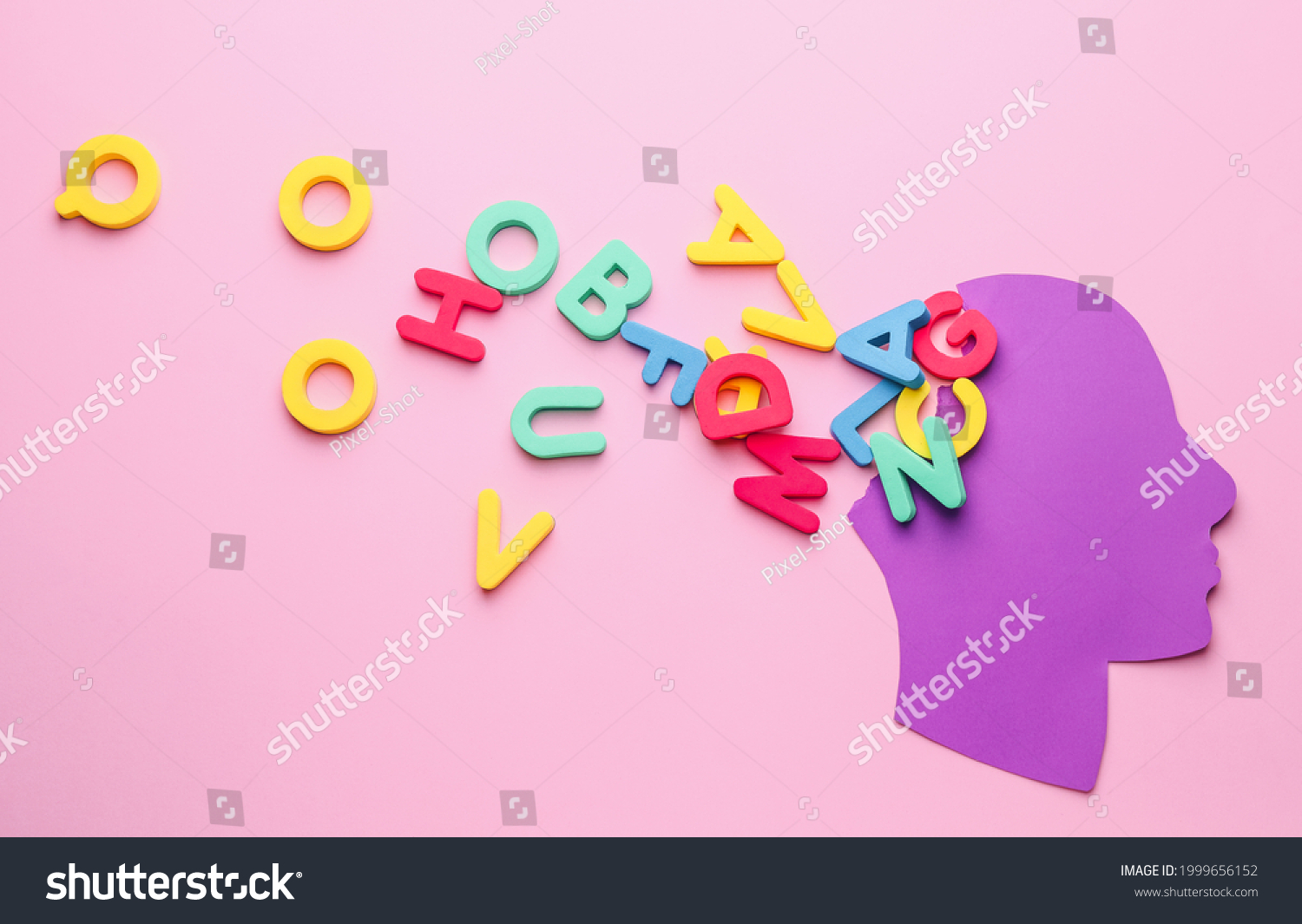 Paper human head with letters on color background. Dyslexia concept #1999656152