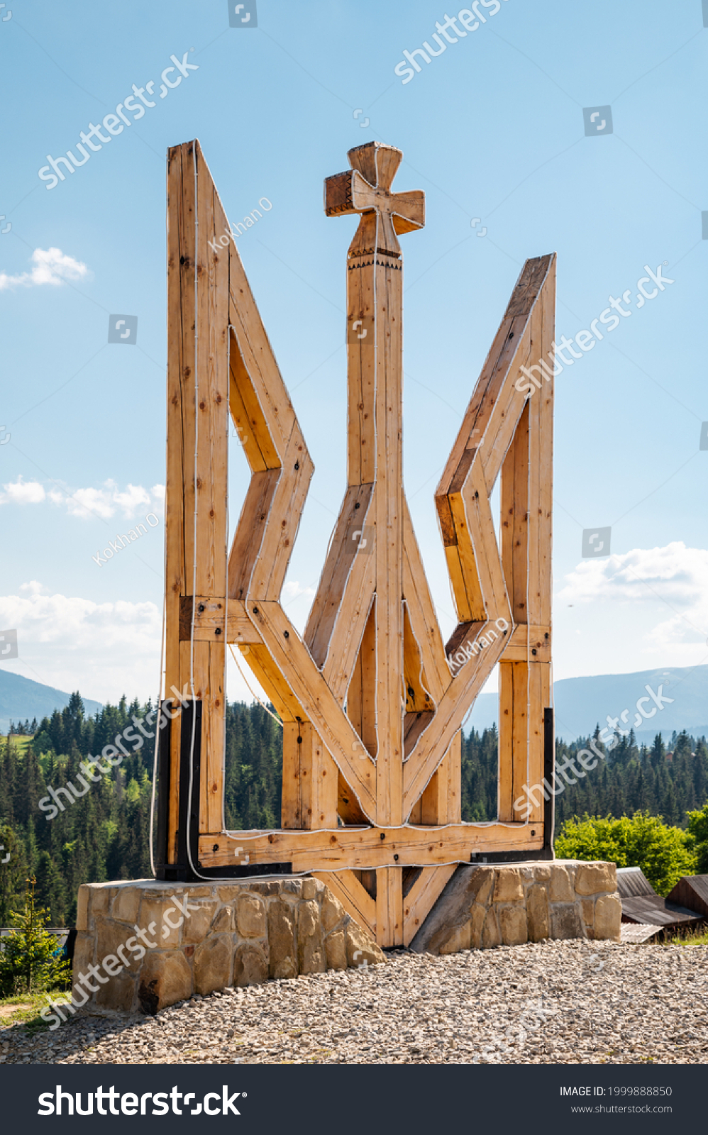 Emblem of Ukraine.
A large yellow wooden trident set on a stone high in the Carpathian mountains. #1999888850