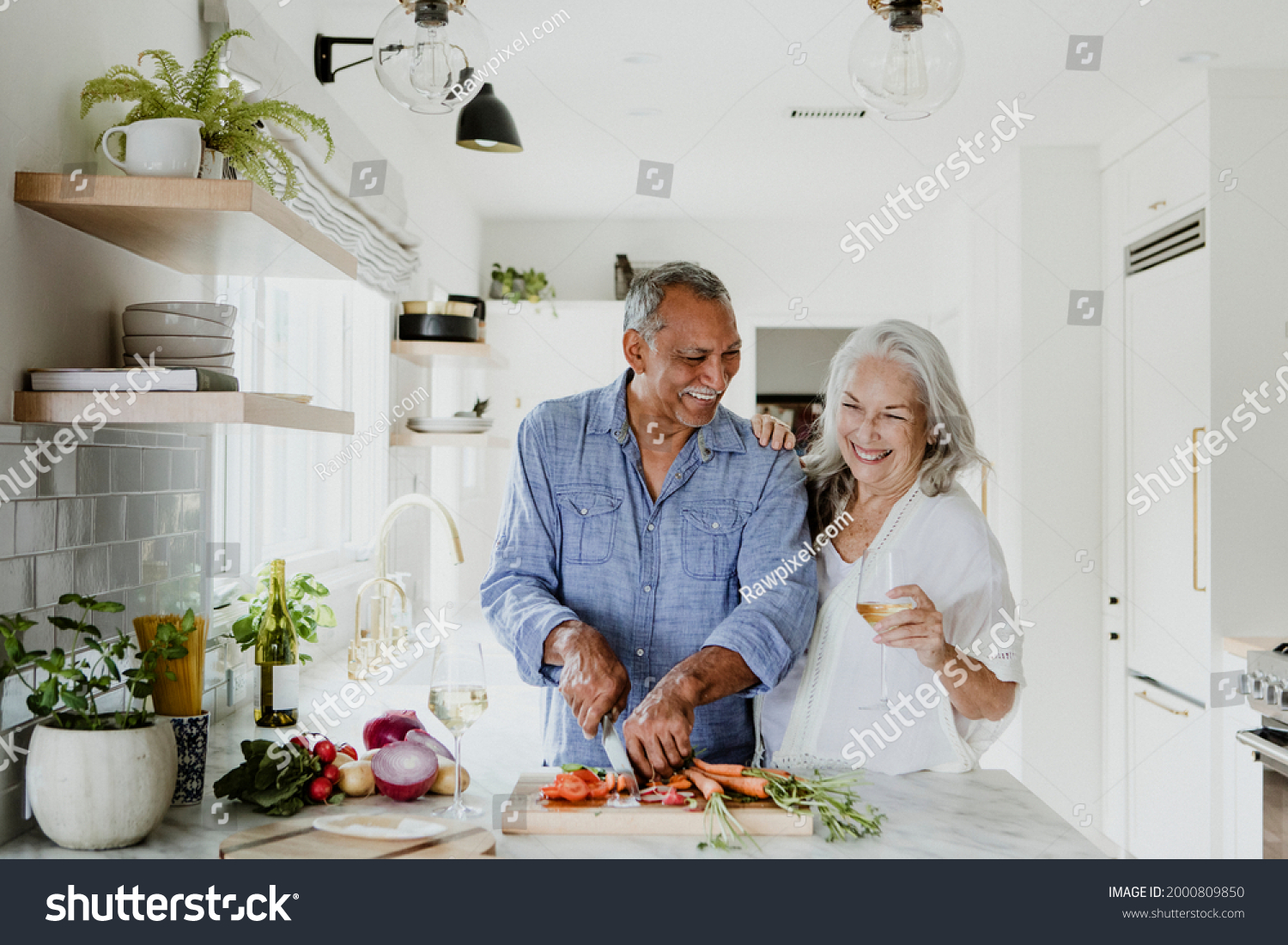 Elderly couple cooking in a kitchen #2000809850
