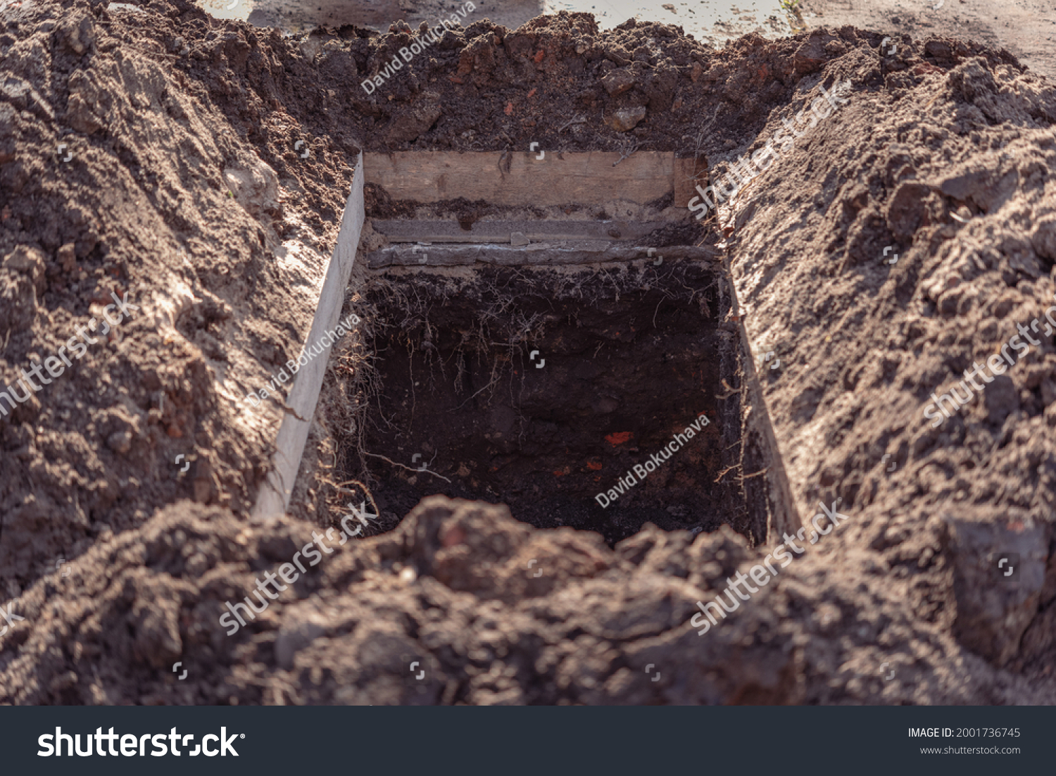 Freshly dug grave pit at cemetery, a close-up. #2001736745