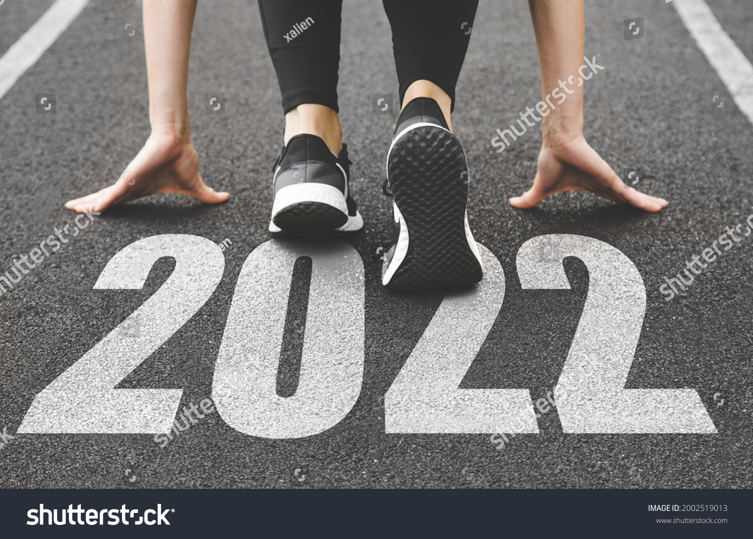 close-up of female feet in sneakers at the start. Beginning and start of the new year 2022, goals and plans for the next year #2002519013