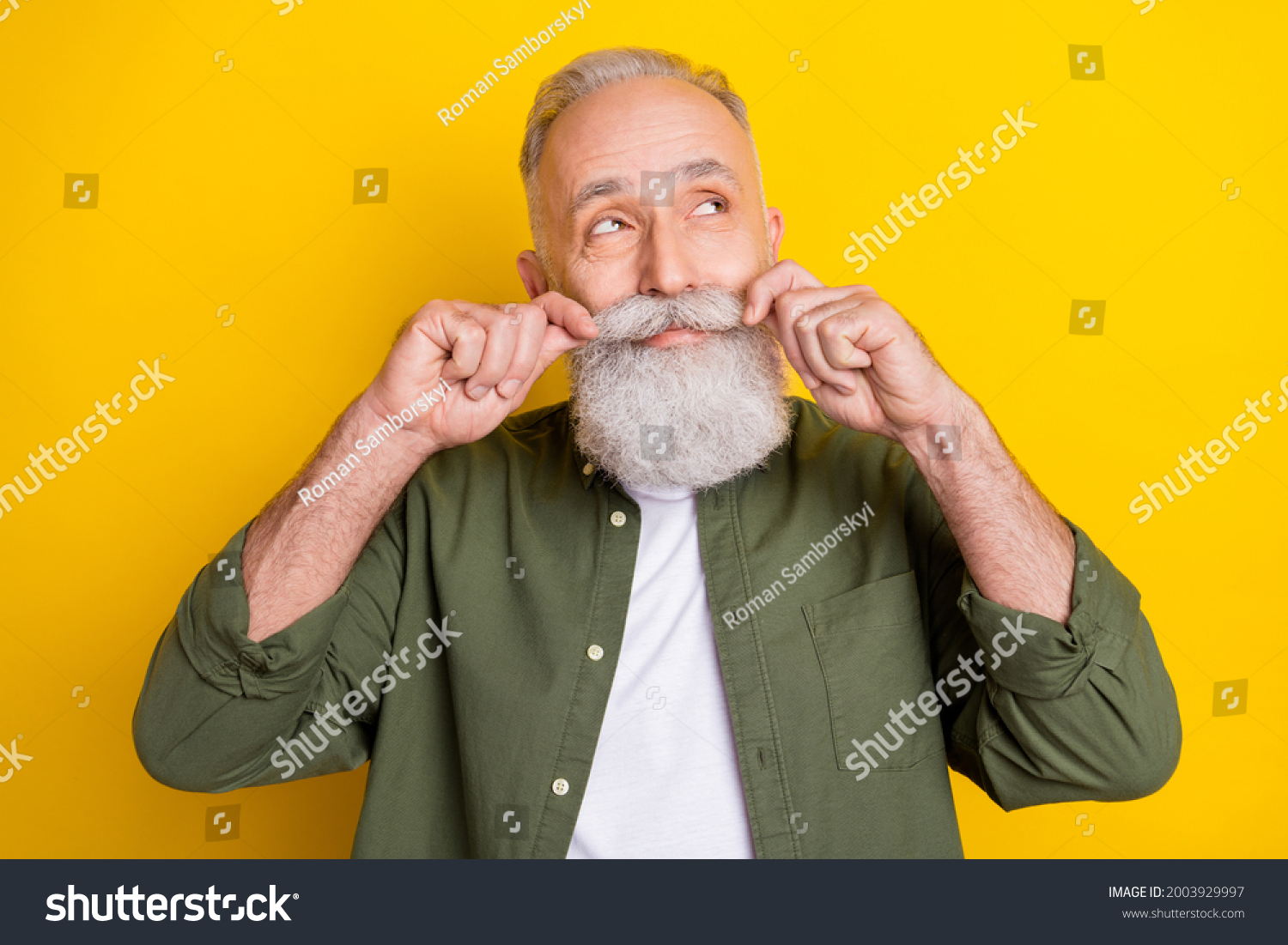 Photo portrait of senior man touching mustache looking dreamy empty space isolated vibrant yellow color background #2003929997