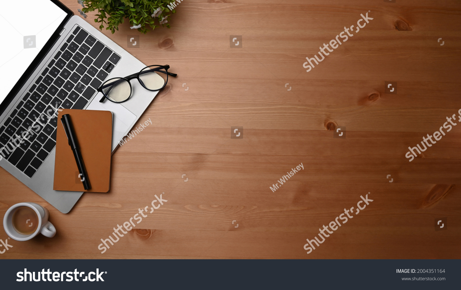 Overhead shot computer laptop, notebook and coffee cup on wooden desk. #2004351164