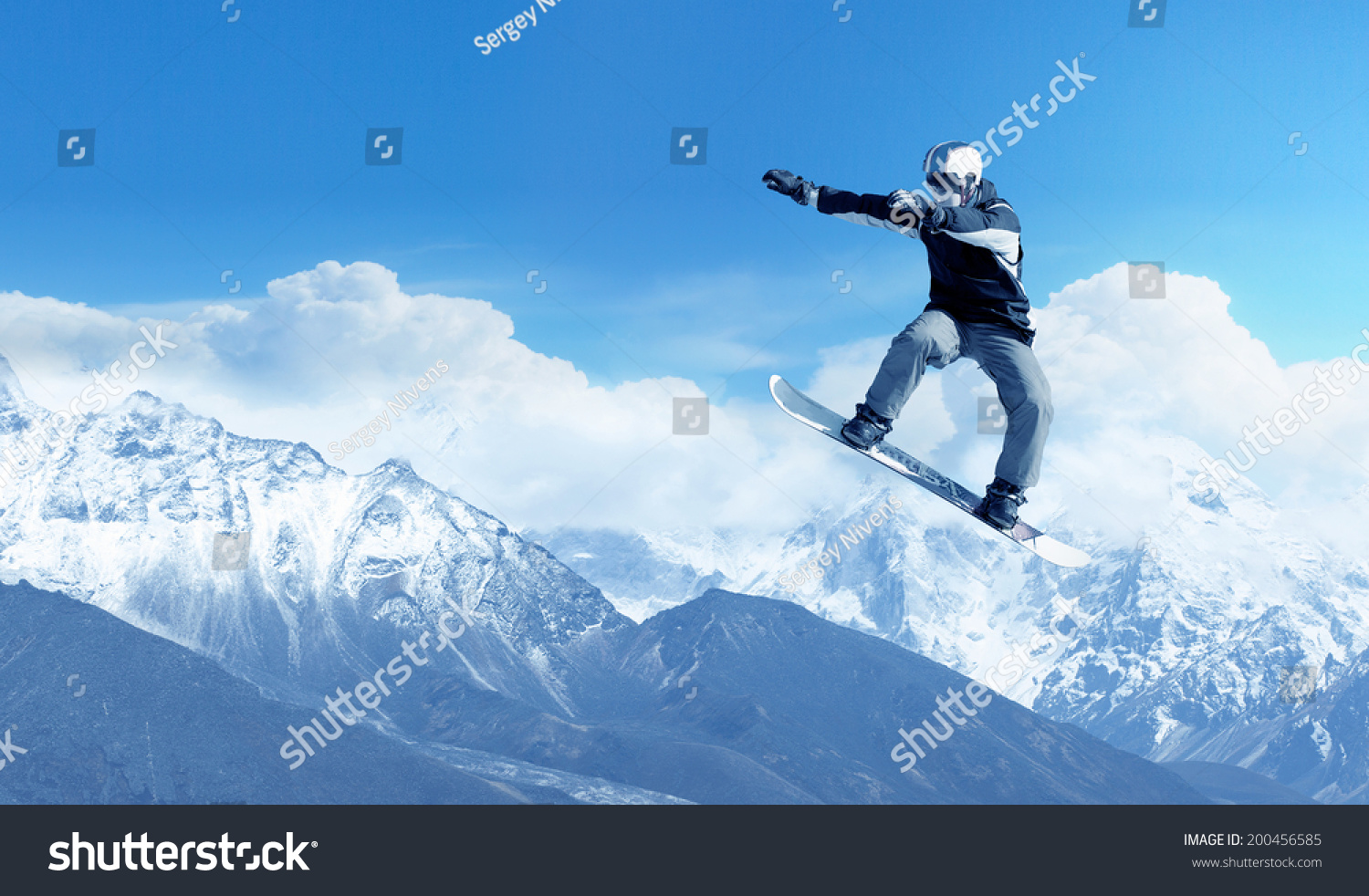 Snowboarder making jump high in clear sky #200456585