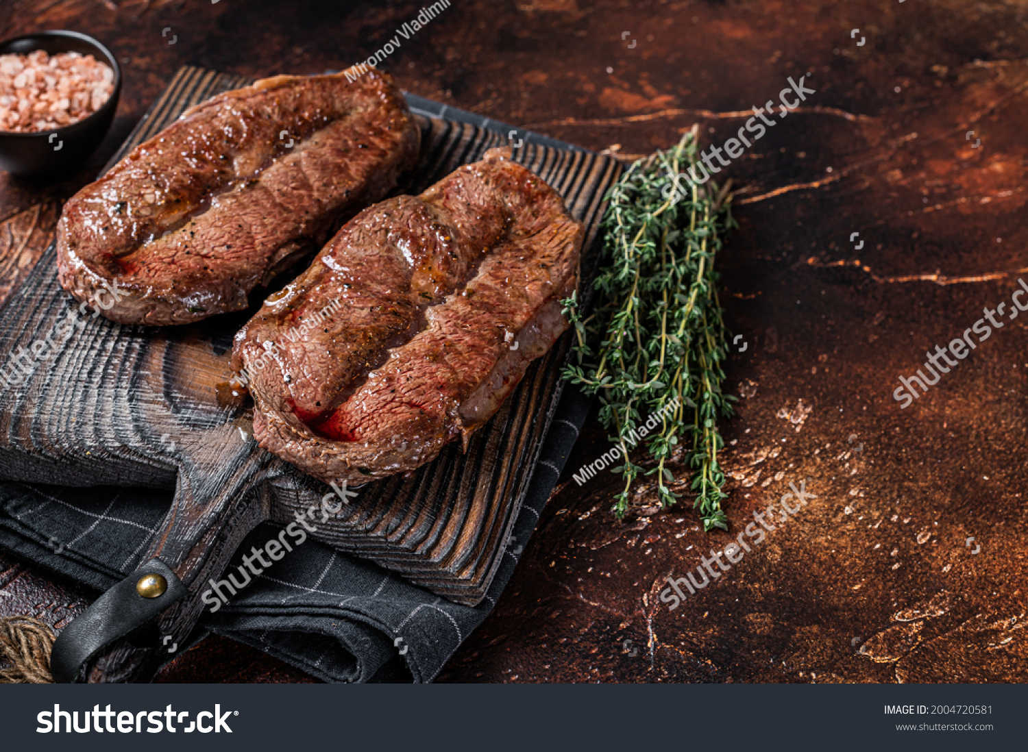 BBQ roasted Shoulder Top Blade cut or Australia wagyu oyster blade beef steak. Dark background. Top View. Copy space #2004720581