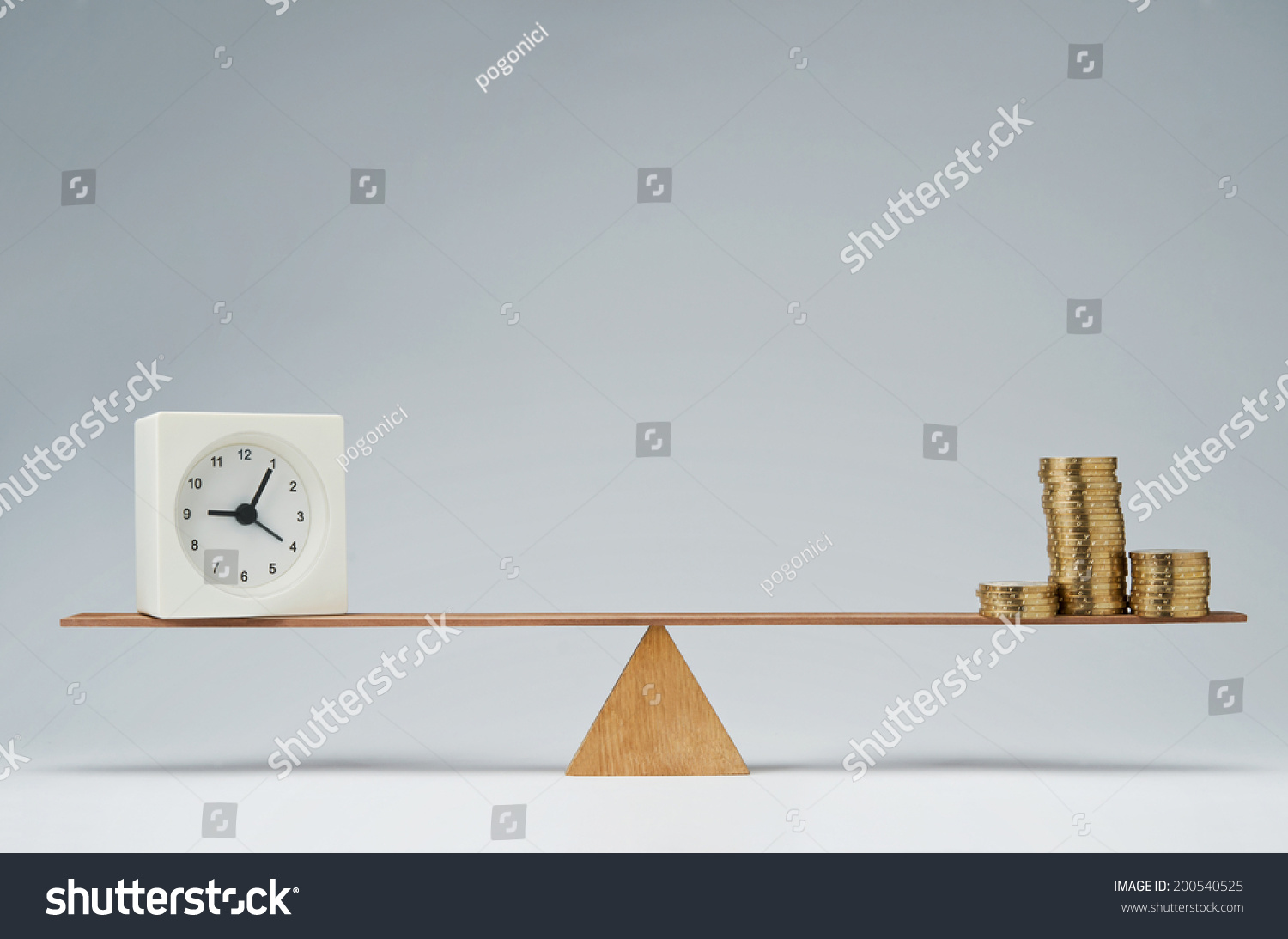 Clock and money coins stack balancing on a seesaw #200540525