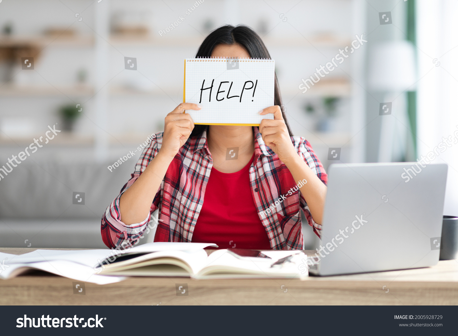 Stressed Unrecognizable Female Holding Leaflet With Drawn Help Word In Front Of Face While Study Online With Laptop At Home, Student Woman Suffering Problems With Remote Education, Closeup #2005928729