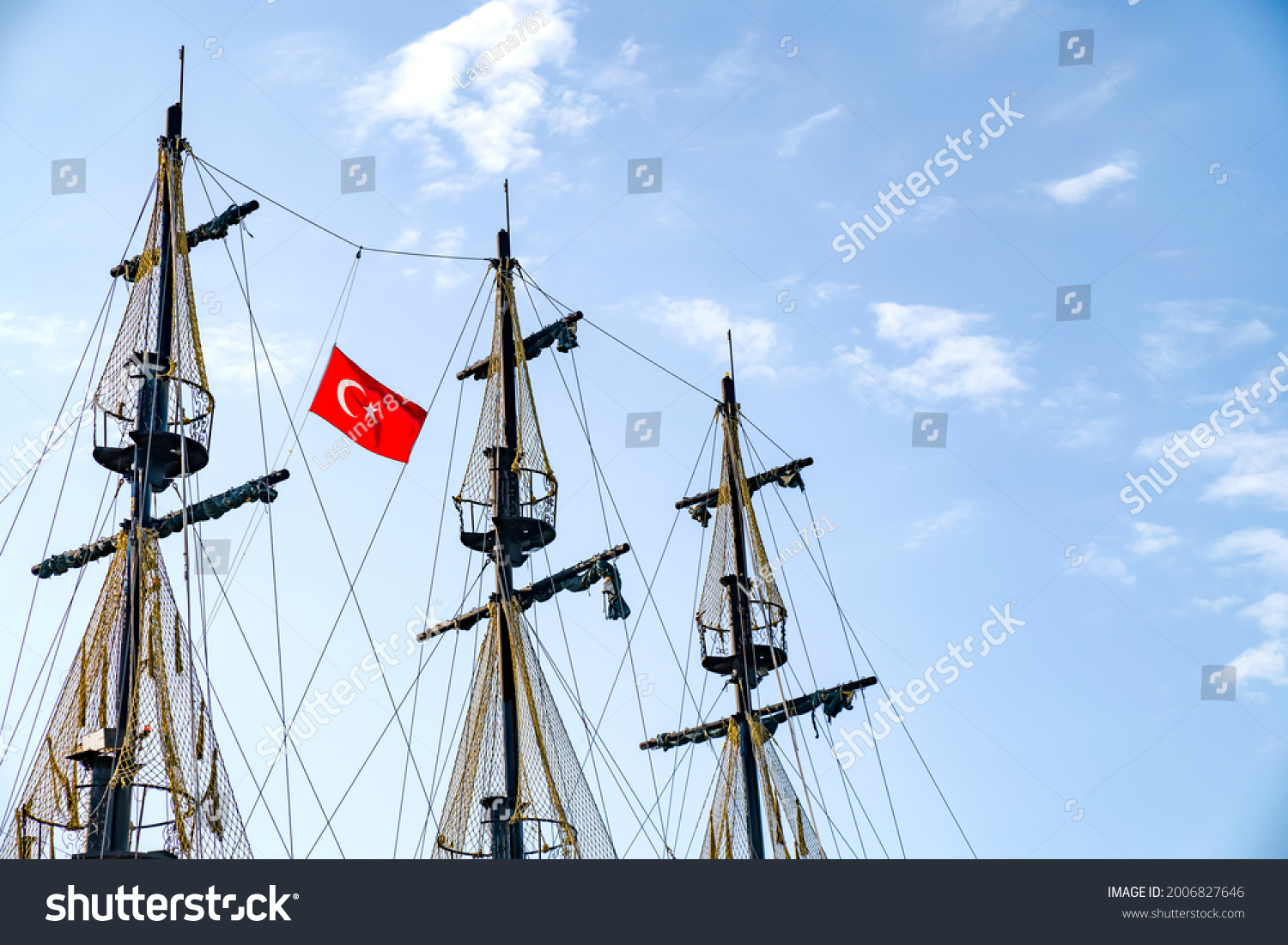 The masts of the ship with the Turkish flag on the background of the blue sky. The concept of travel and freedom #2006827646